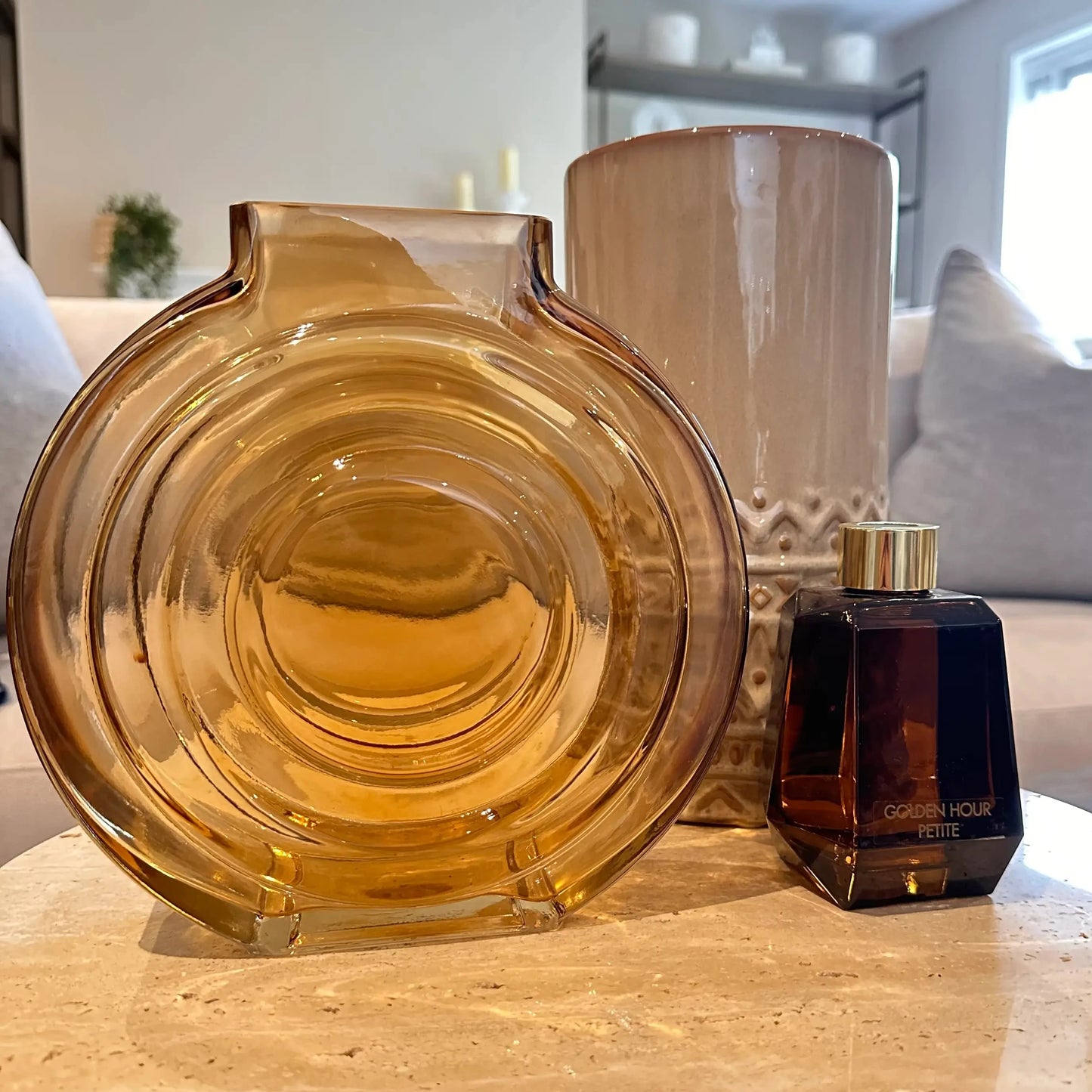 orange-amber-glass-round-vase-with-brown-diffuser-on-terrazzo-stone-tray-with-ball-feet-at-albury-house-interiors