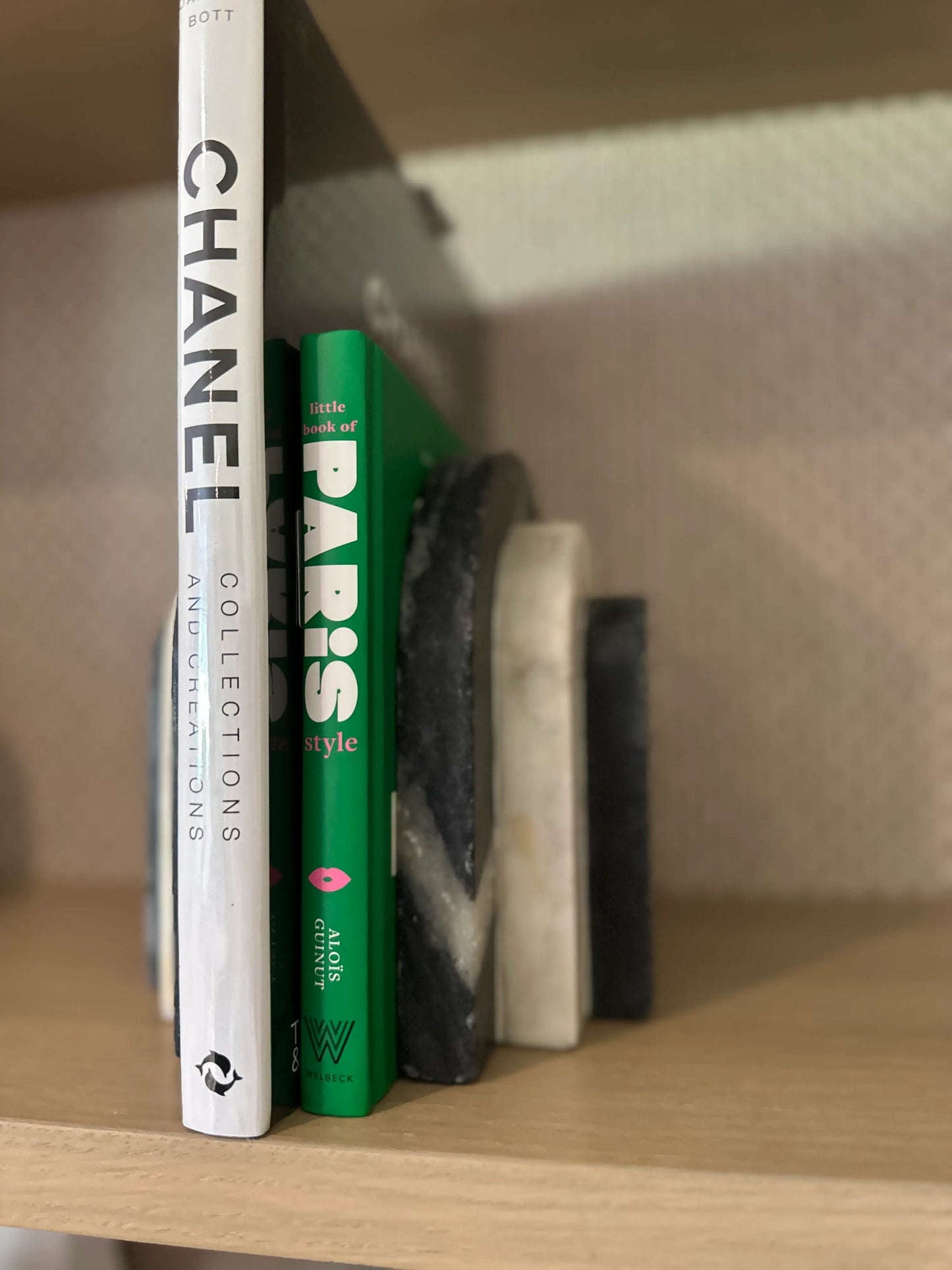 black-and-white-natural-marble=arched-curved-bookends-with-chanel-collections-and-creations-book-and-green-little-book-of-paris-style-at-albury-house-interiors-essex