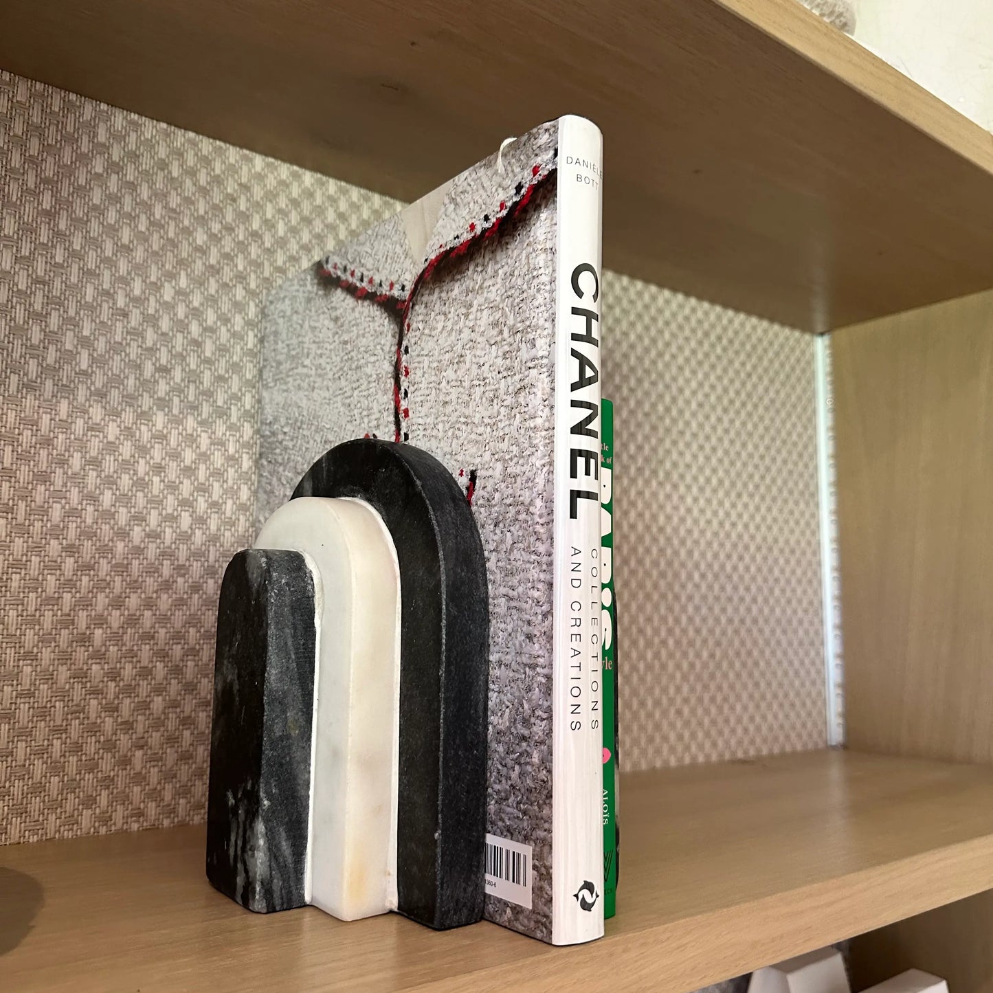 black-and-white-natural-marble=arched-curved-bookends-with-chanel-collections-and-creations-book-and-green-little-book-of-paris-style-at-albury-house-interiors-essex