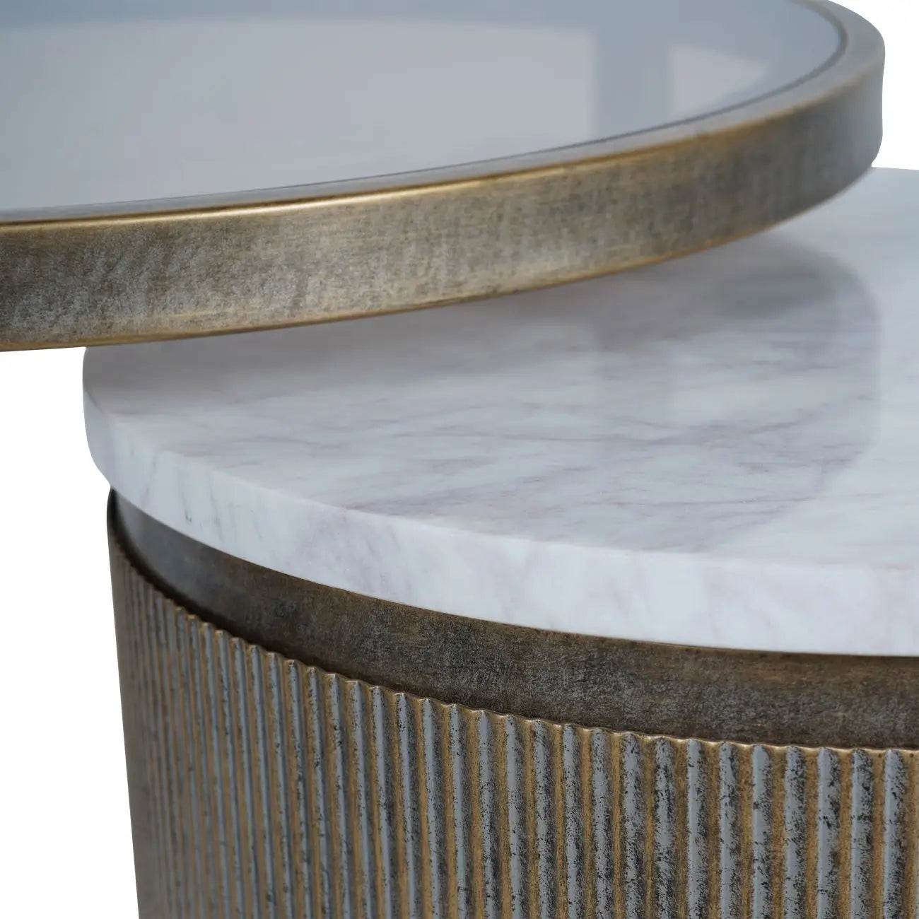 Set of two nesting round side tables, finished in antique bronze with ribbed detailing, and marble and smoked glass table tops. As used by interior designers, available to purchase from Albury House Interiors.