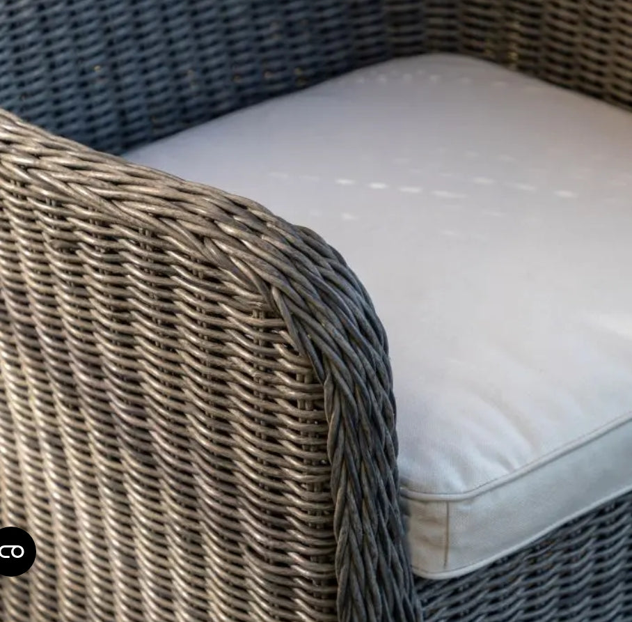 A 3-piece outdoor patio bistro set featuring two grey woven wicker armchairs and a matching round wicker side table on a solid white background.
