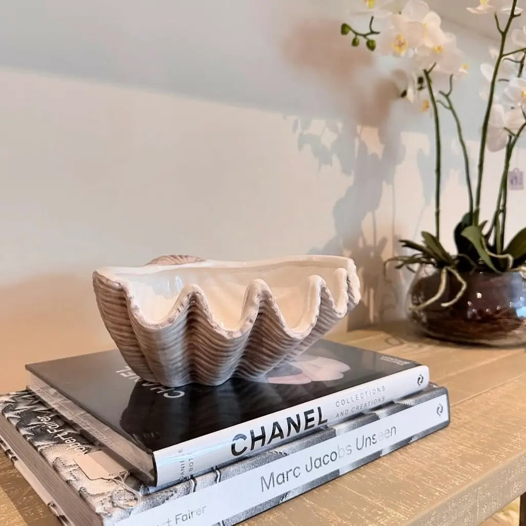 white-and-grey-ceramic-clam-shell-bowl-placed-on-chanel-collections-and-creations-book-and-marc-jacobs-unseen-coffee-table-book-alt-albury-house-interiors-shop-essex