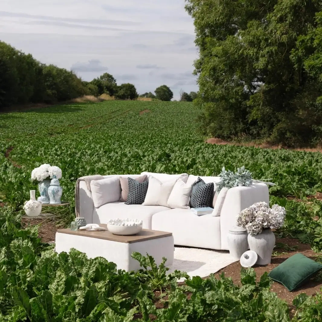Cleo white 3 seater sofa with matching storage coffee table, styled in a farmers field with ginger jars and faux flowers, green cushions, ceramic bowls and vases. Styled by Albury House Interiors, Matching Tye Essex.