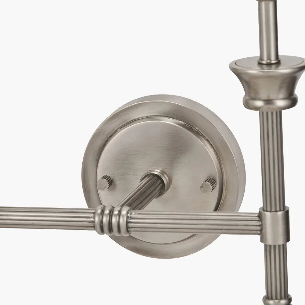 closeup-of-brushed-silver-cast-brass-double-wall-light-with-stepped-backplate-ribbed-detail-and-taupe-cotton-shades-at-albury-house-interiors