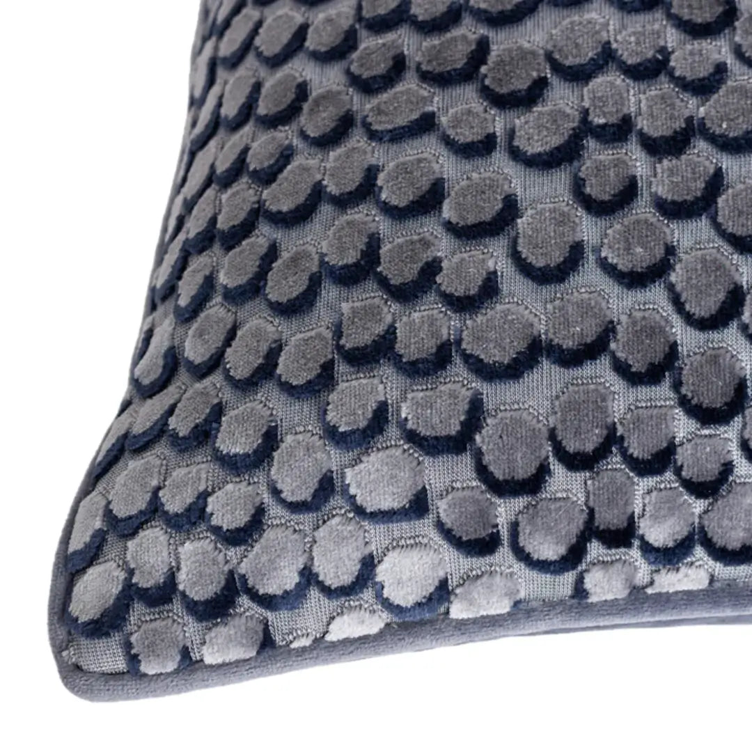 Square navy velvet cushion with bubble effect pattern on front face and plain soft velvet on the reverse side, with matching piped edges. Available at Albury House Interiors, home decor store in Essex.