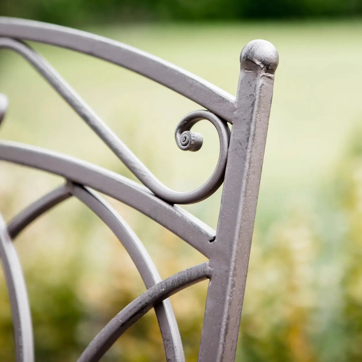 closeup of tilbury metal brown outdoor bistro set with two folding chairs and a round table at Albury house interiors