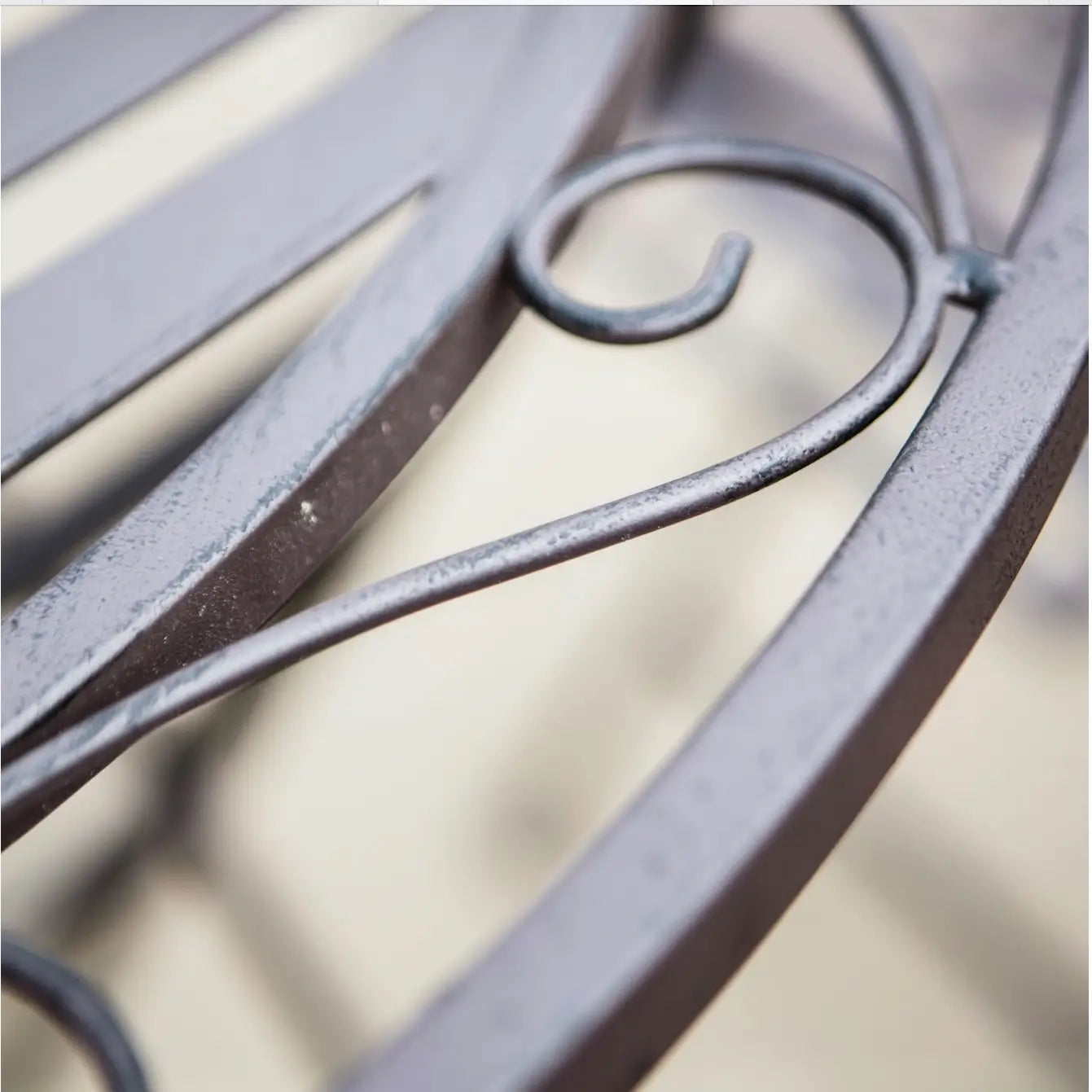 closeup of tilbury metal brown outdoor bistro set with two folding chairs and a round table at Albury house interiors