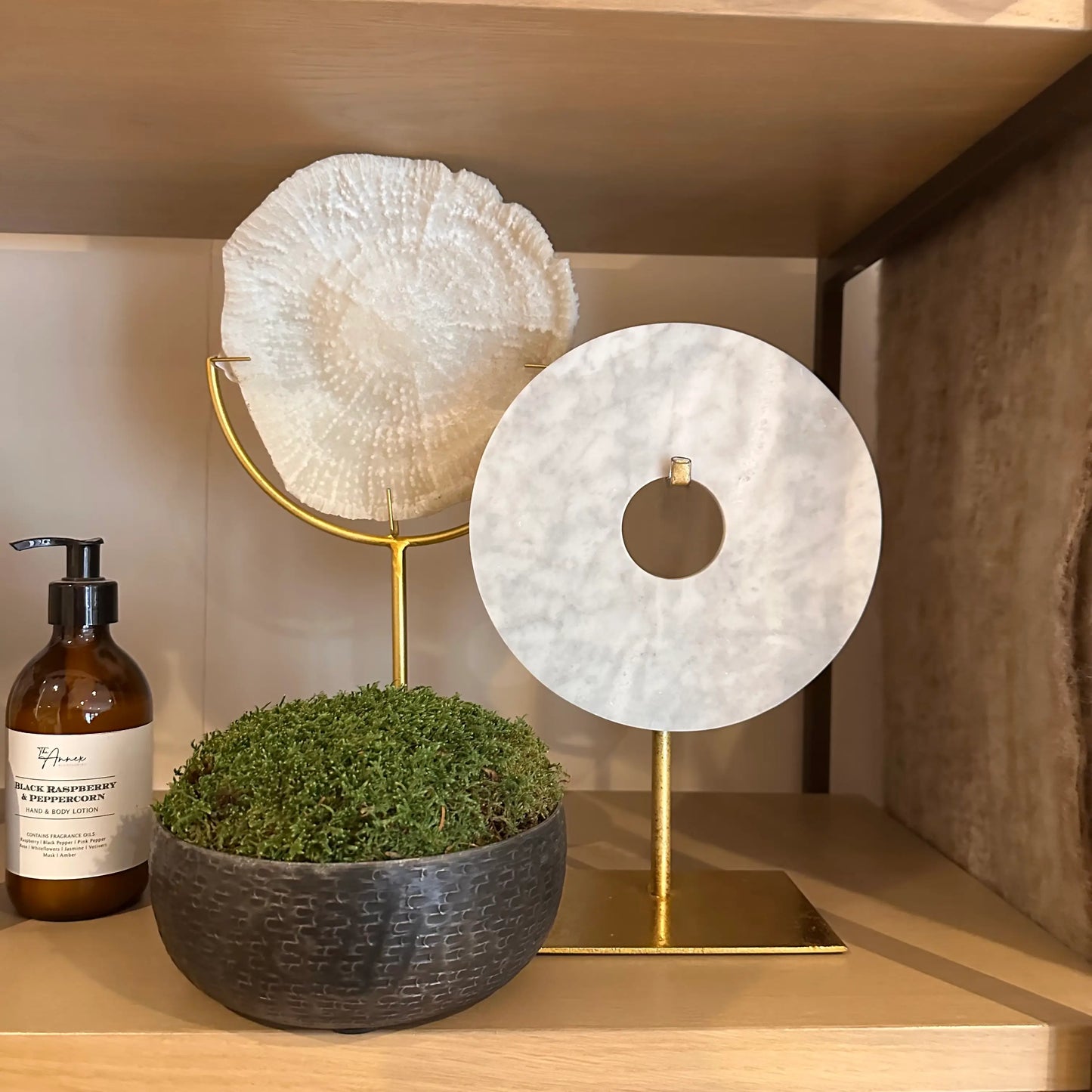 faux-cream-coral-on-gold-stand-with-white-marble-and-marble-disc-on-gold-stand-with-graphite-moss-bowl-at-albury-house-interiors