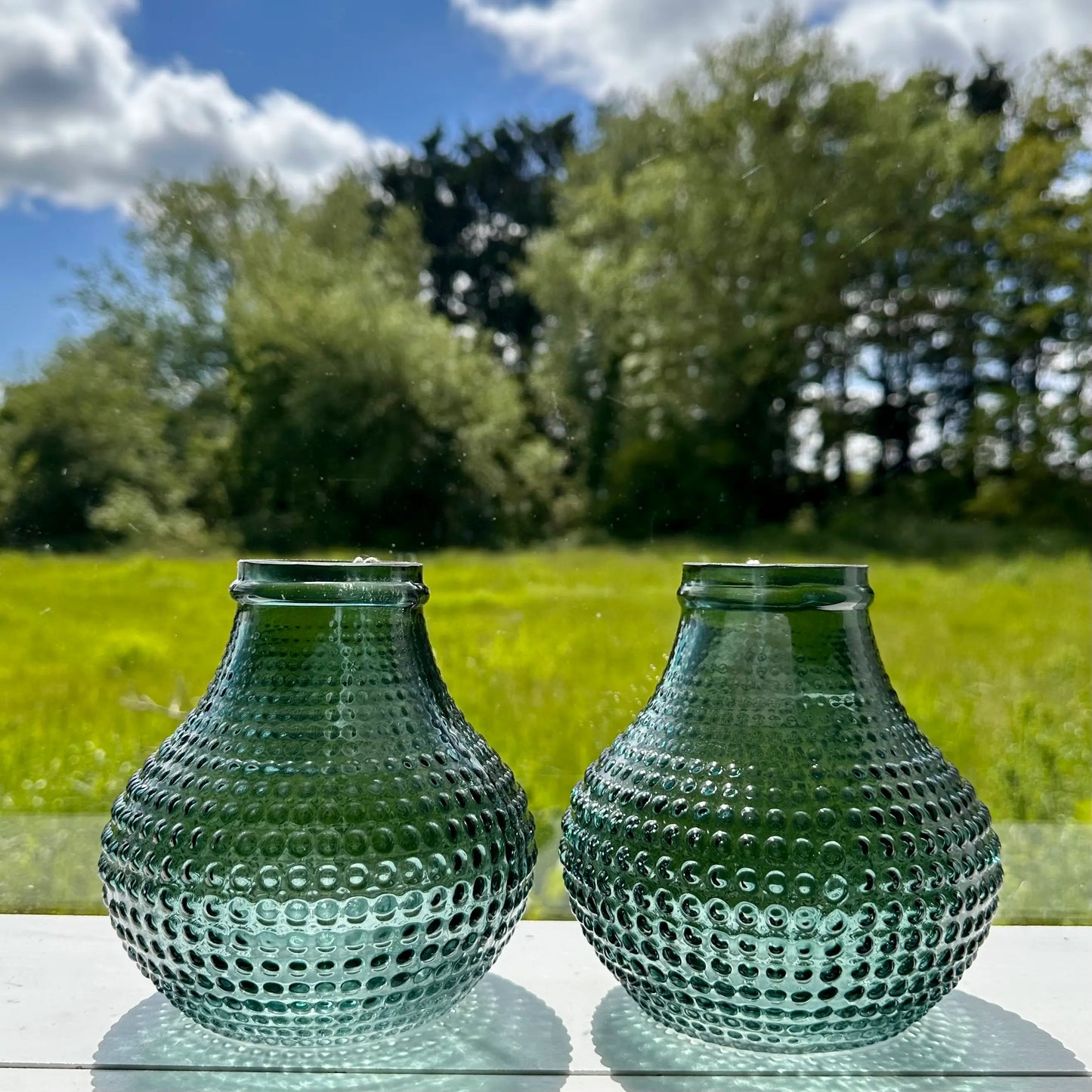 Green glass dotted bud vases perfect for small blooms, fully waterproof, available at Albury House Interiors.