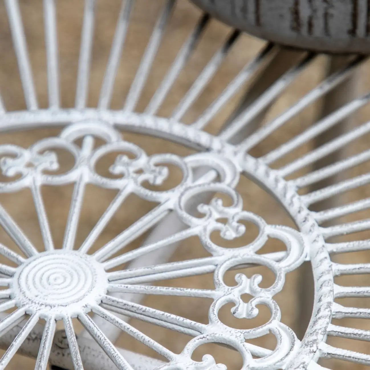 white metal outdoor table and two chairs on a patio deck from Albury house interiors essex