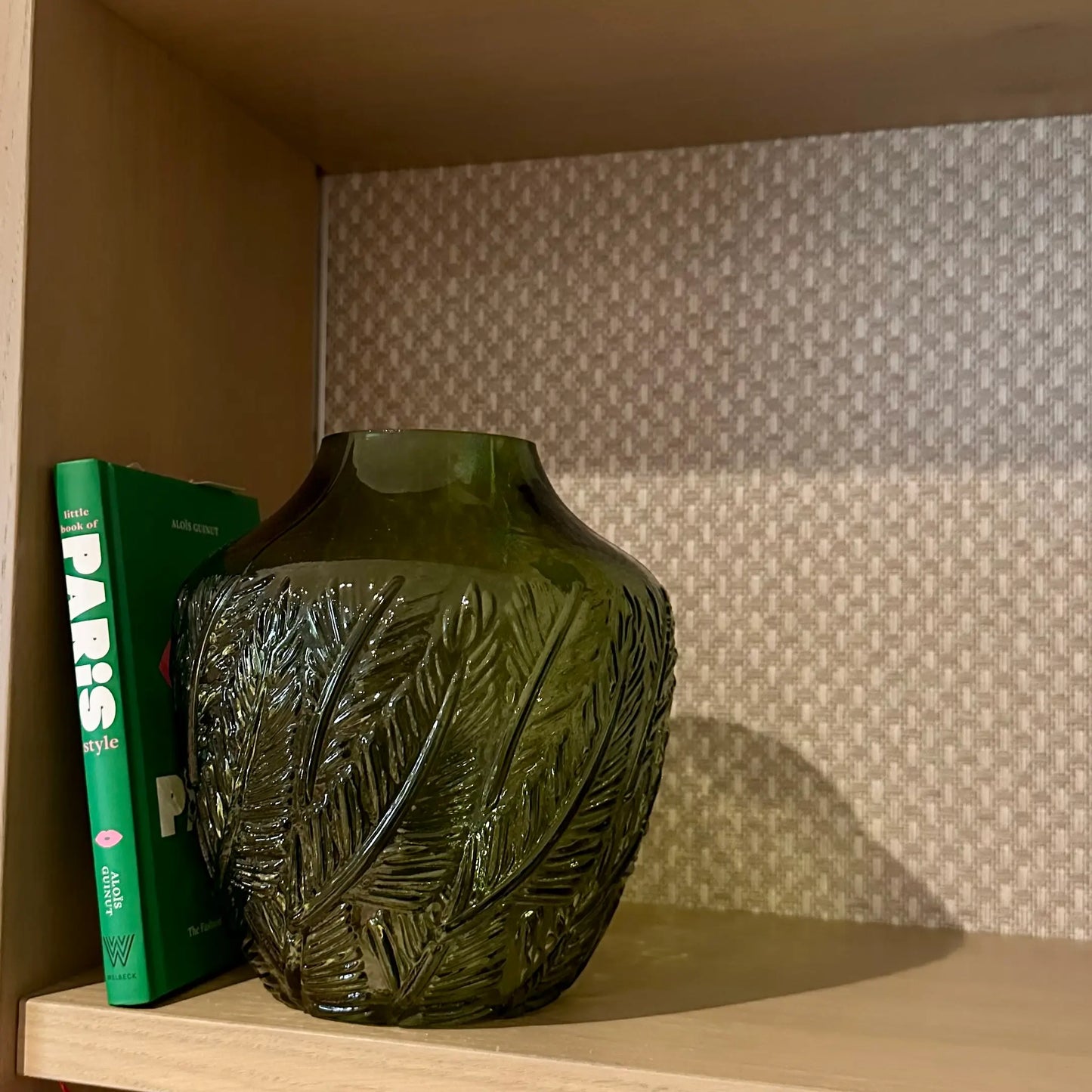 kew-green-glass-botanical-vase-on-shelving-unit-with-green-book-at-albury-house-interiors