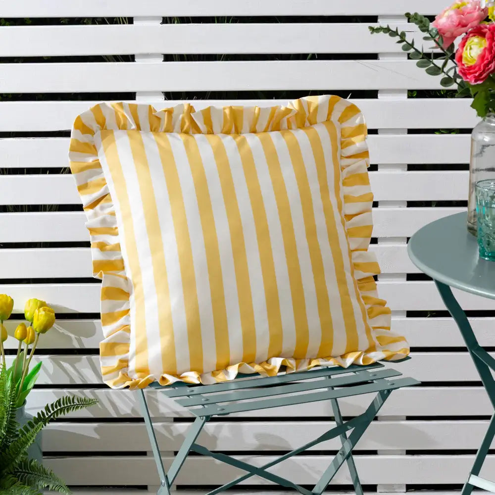 Lemon yellow and white thick striped outdoor weatherproof square cushion, with ruffled frill edge at Albury House Interiors