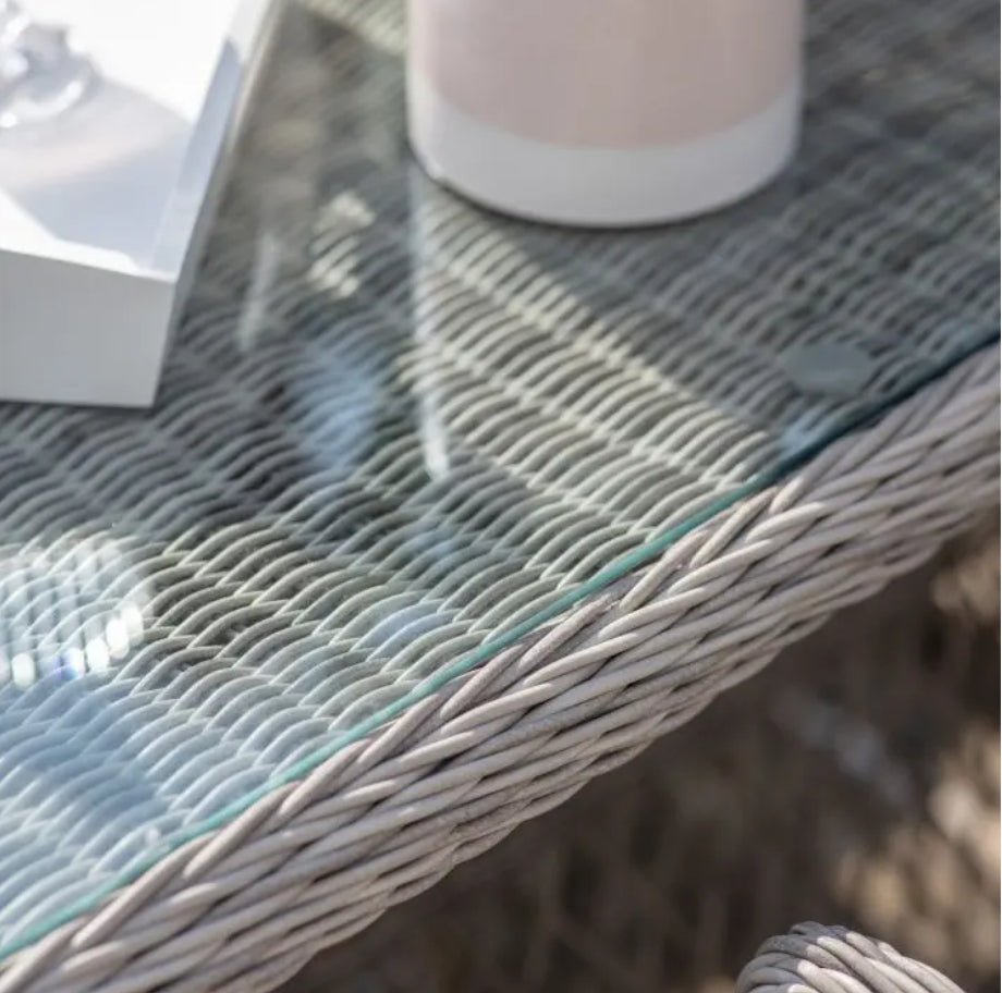 Moreton stone grey colour rattan outdoor furniture, 6 chairs and a glass topped oval dining table with showerproof seat and back cushions, available at Albury House Interiors