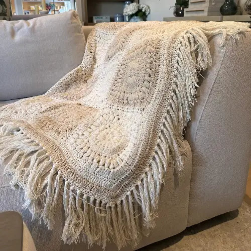 Beautiful white and natural coloured crochet throw blanket, crafted from 100% cotton in India. Complete with fringed tassel edge all the way round. Available at Albury House Interiors.