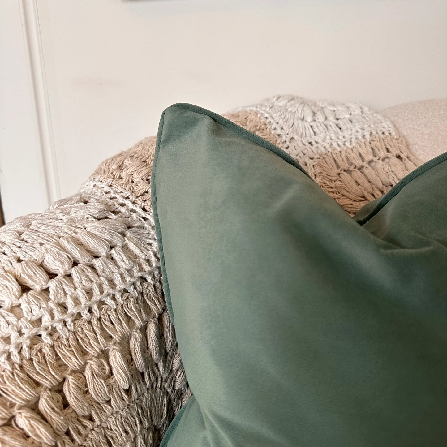 sage-green-velvet-square-shaped-cushion-wth-piped-edges-and-feather-insertson-beige-bespoke-sofa-at-albury-house-interiors-home-decor-shop-essex