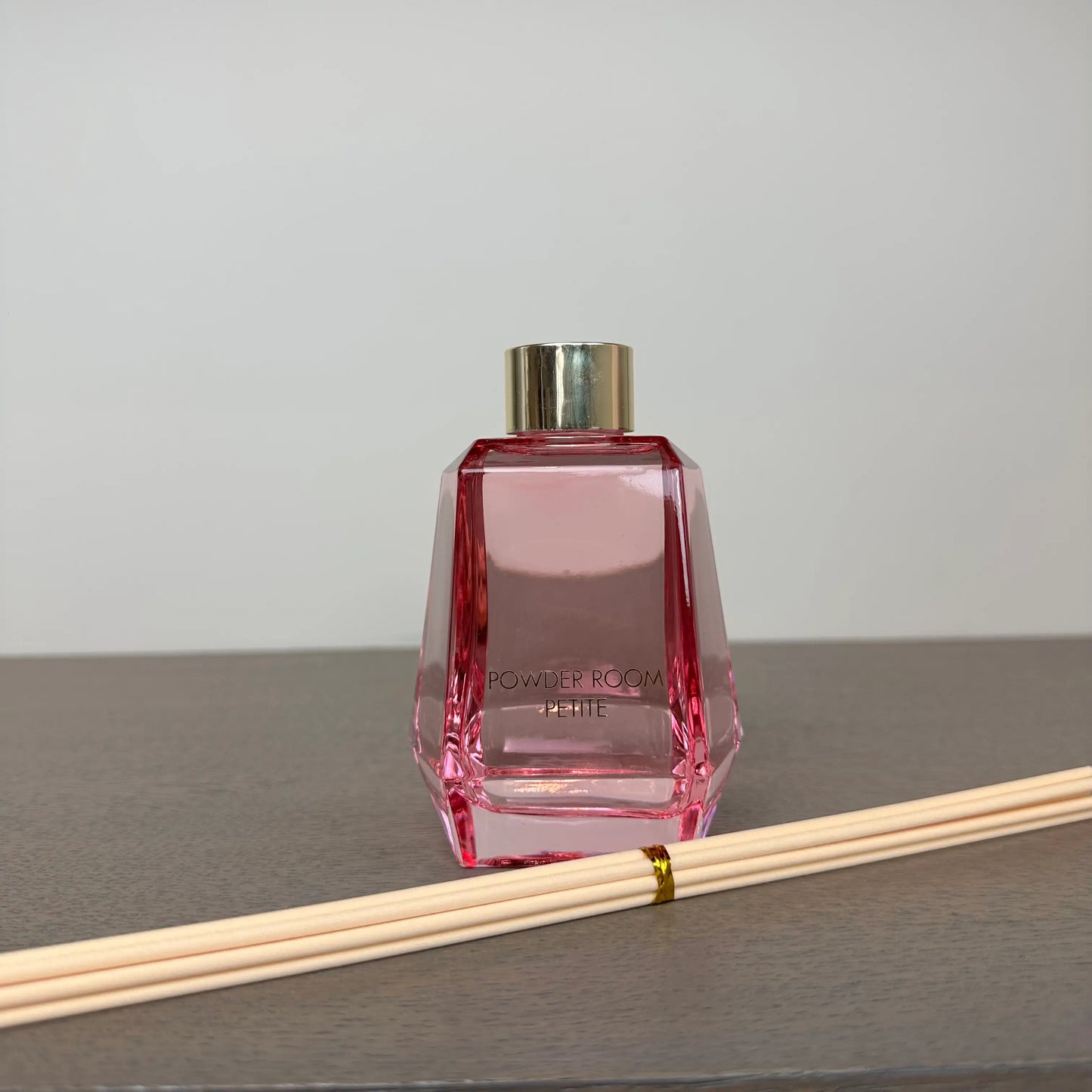 pink-glass-powder-room-reed-diffuser-with-rose-and-oud-scent-comes-gift-boxes-with-wooden-reeds-from-albury-house-interiors
