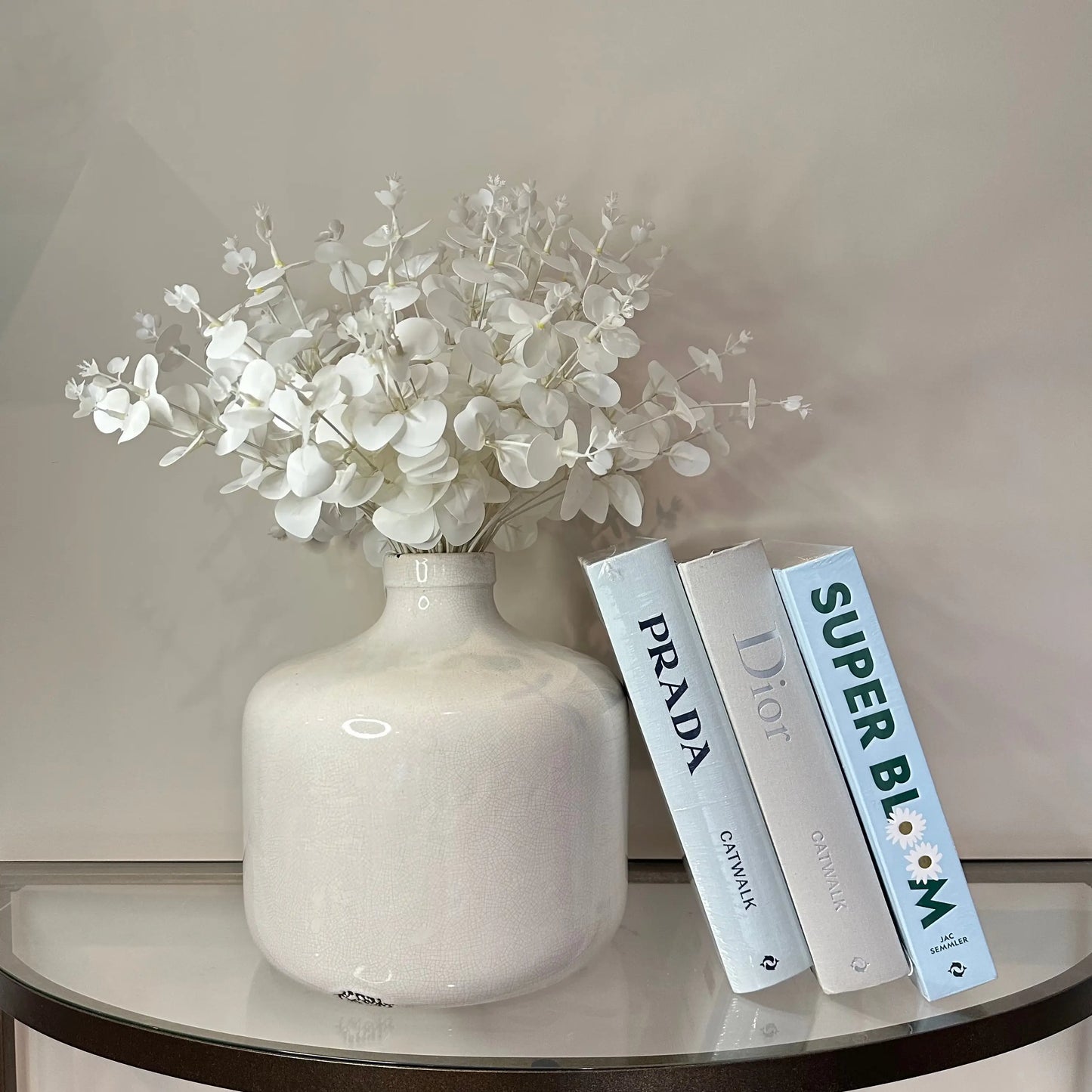 blue-prada-and-dior-catwalk-hardback-book-and-blue-superbloom-gardening-coffee-table-book-with-white-chive-vase-at-albury-house-interiors