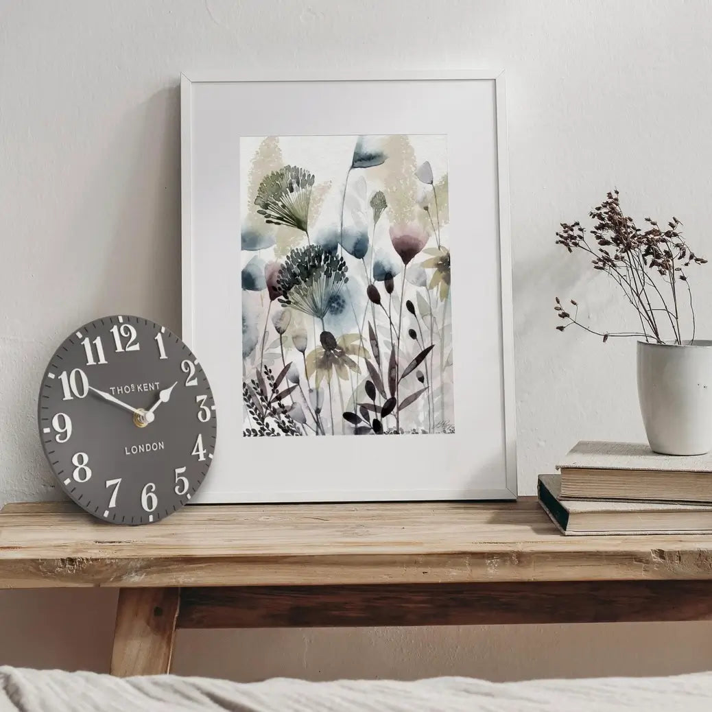 small-round-thomas-kent-mantel-clock-with-dark-grey-face-and-white-numbers-and-hands-at-albury-house-interiors