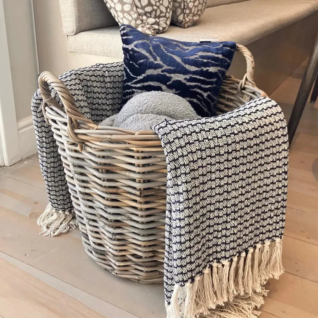 navy-blue-woven-throw-with-tassles-in-single-round-natural-wicker-ratten-basket-with-handles-available-at-albury-house-interiors