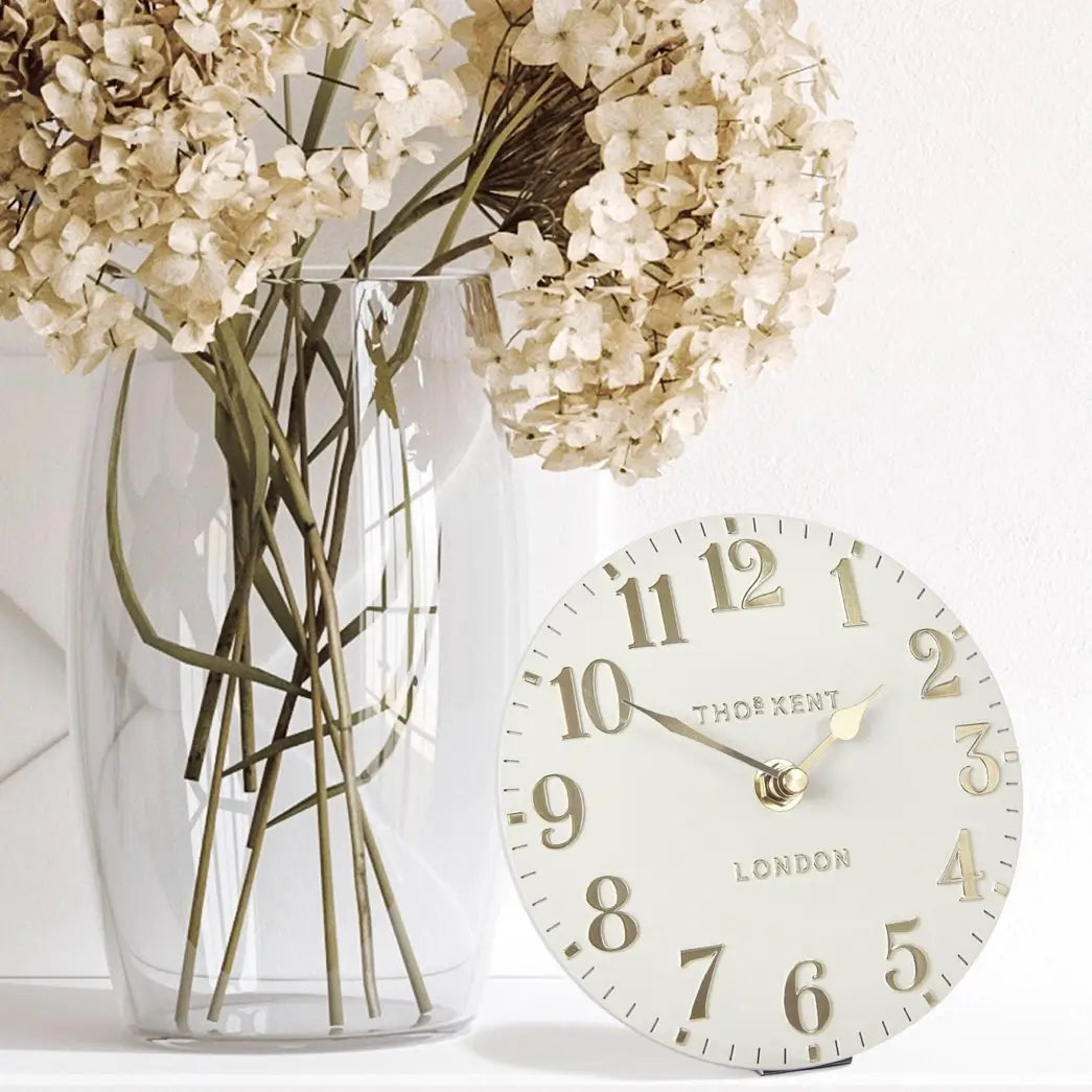 small-round-decorative-mantel-clock-with-cream-face-and-gold-numbers-and-hands-at-albury-house-interiors-essex