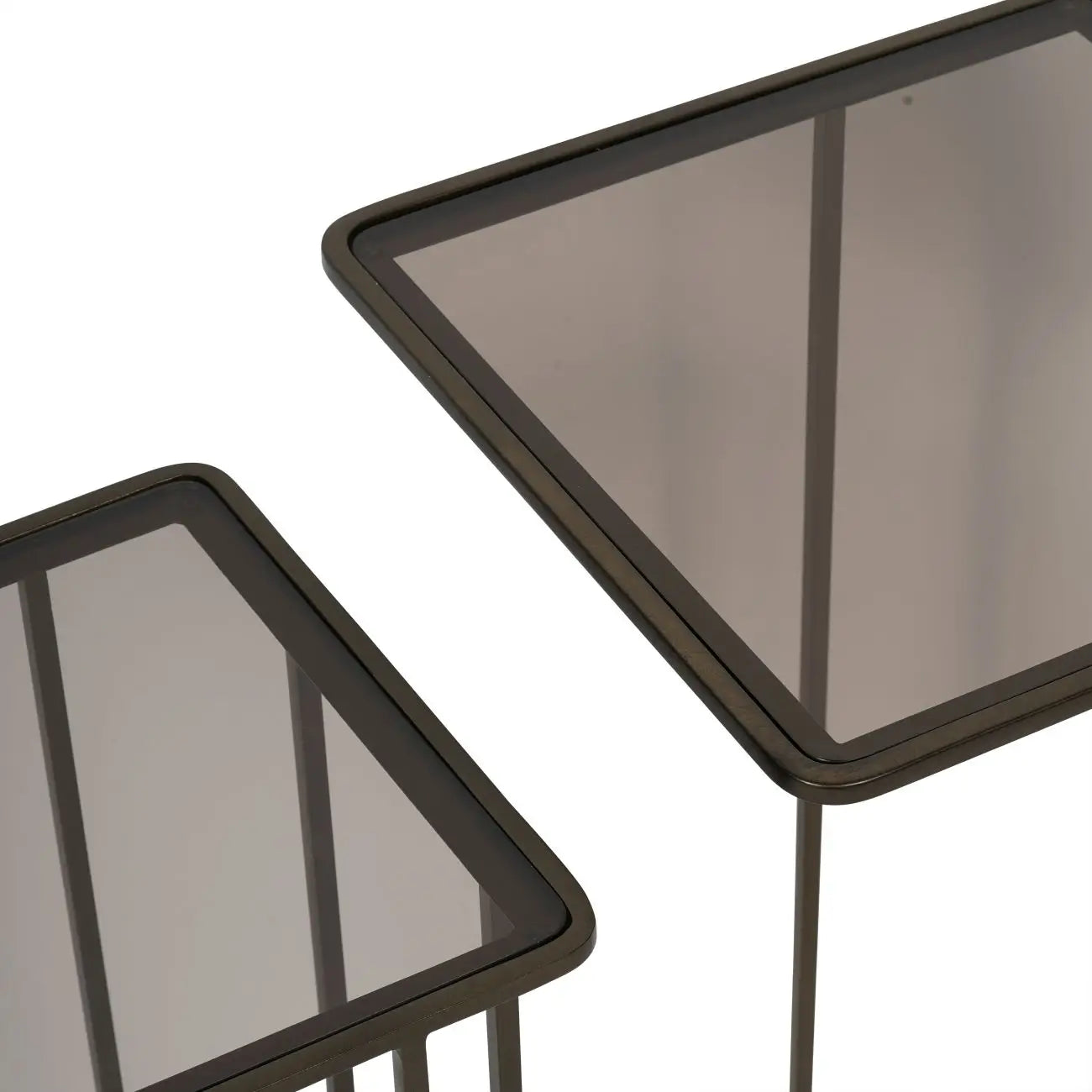 Set of two nesting sofa tables with smoked glass tops and antique bronze metal frames, available to purchase from Albury House Interiors - homewares and free standing furniture in the UK.