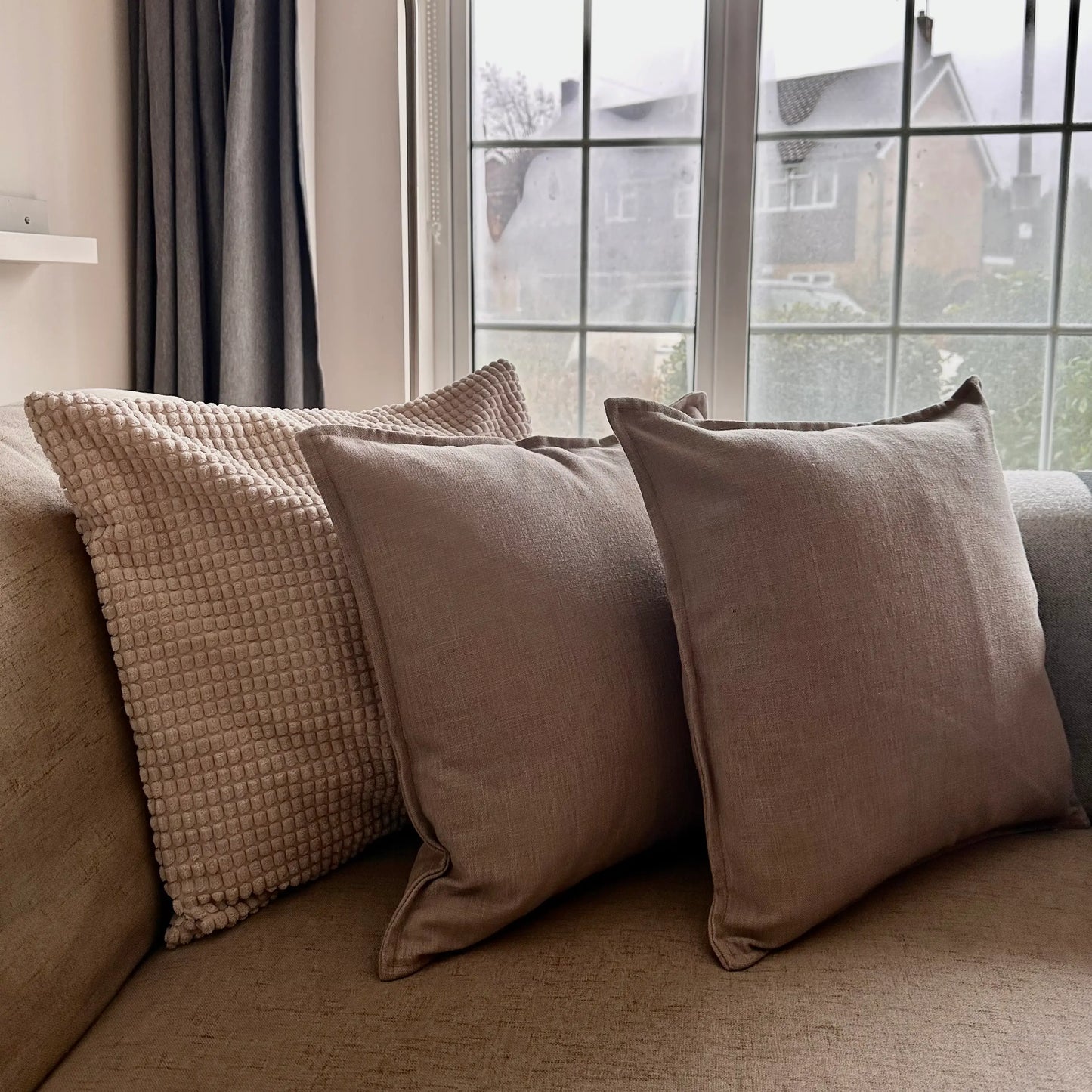 taupe-linen-square-piped-cushions-on-neutral-sofa-at-albury-house-interiors