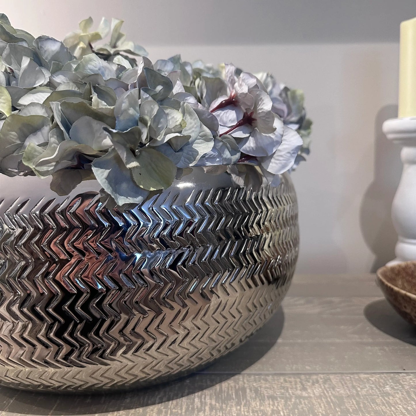 chrome-silver-herringbone-pattern-embossed-large-bowl-with-pastel-faux-hydrangeas-at-albury-house-interiors-matching-tye-essex