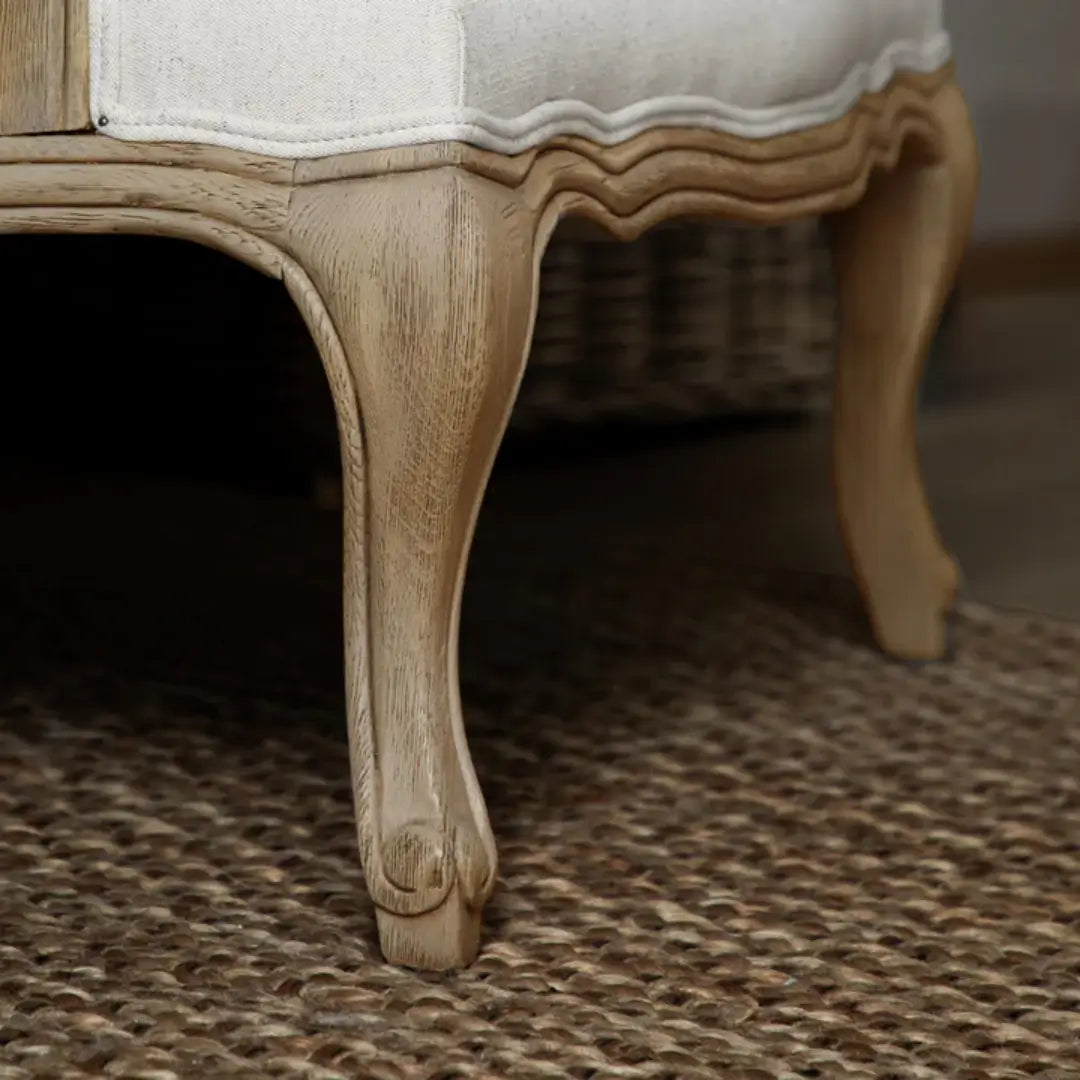 Valais arm chair crafted rom solid oak with rattan back. Cream linen upholstered seat and backrest cushion, with matching armrest padding. Available to purchase from Albury House Interiors in two colours.
