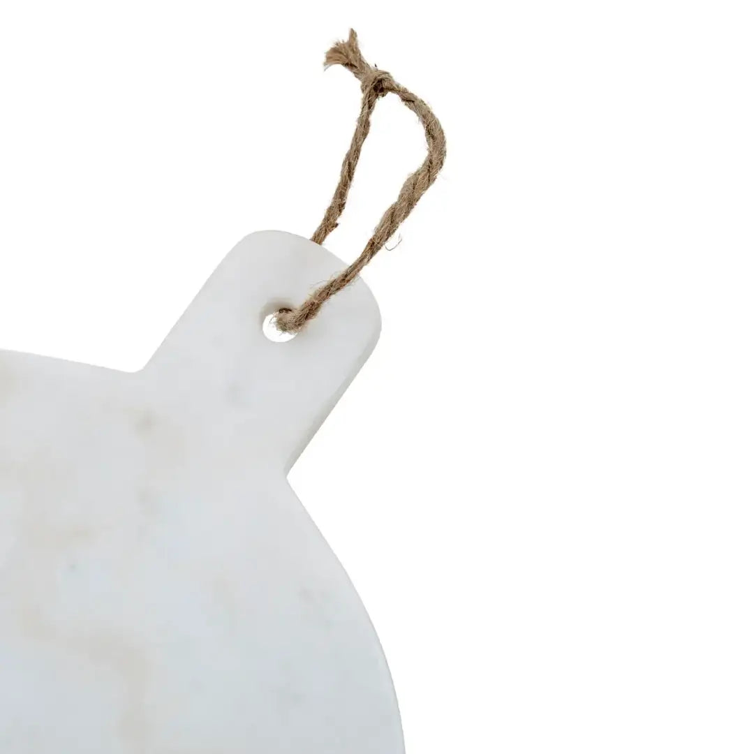 White natural marble round chopping and serving board, both functional and stylish. Comes complete with a string to hang and display. Available to purchase from Albury House Interiors.
