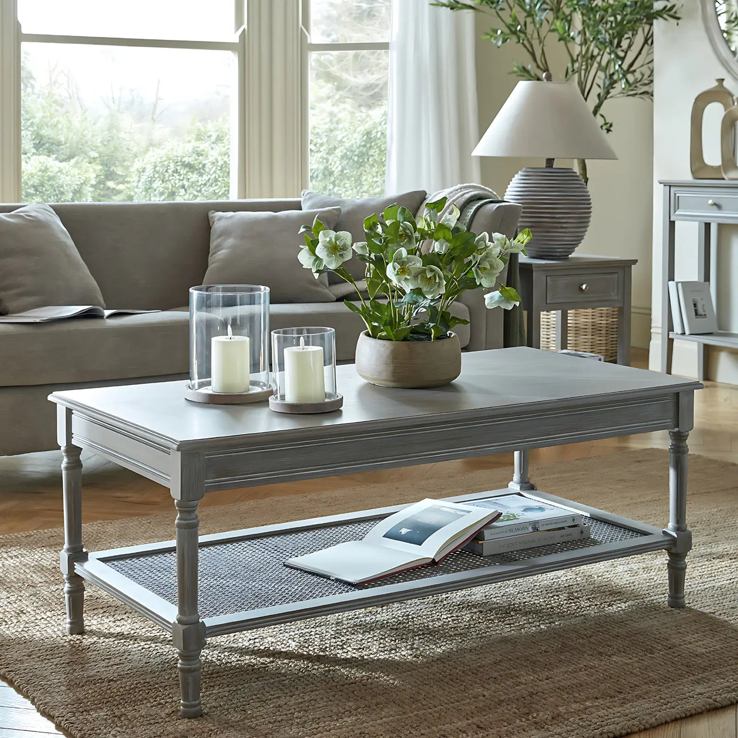 Belgrave solid wood coffee table with intricate tapered legs, a smooth table top and rattan under shelf. Available to purchase from Albury House Interiors.