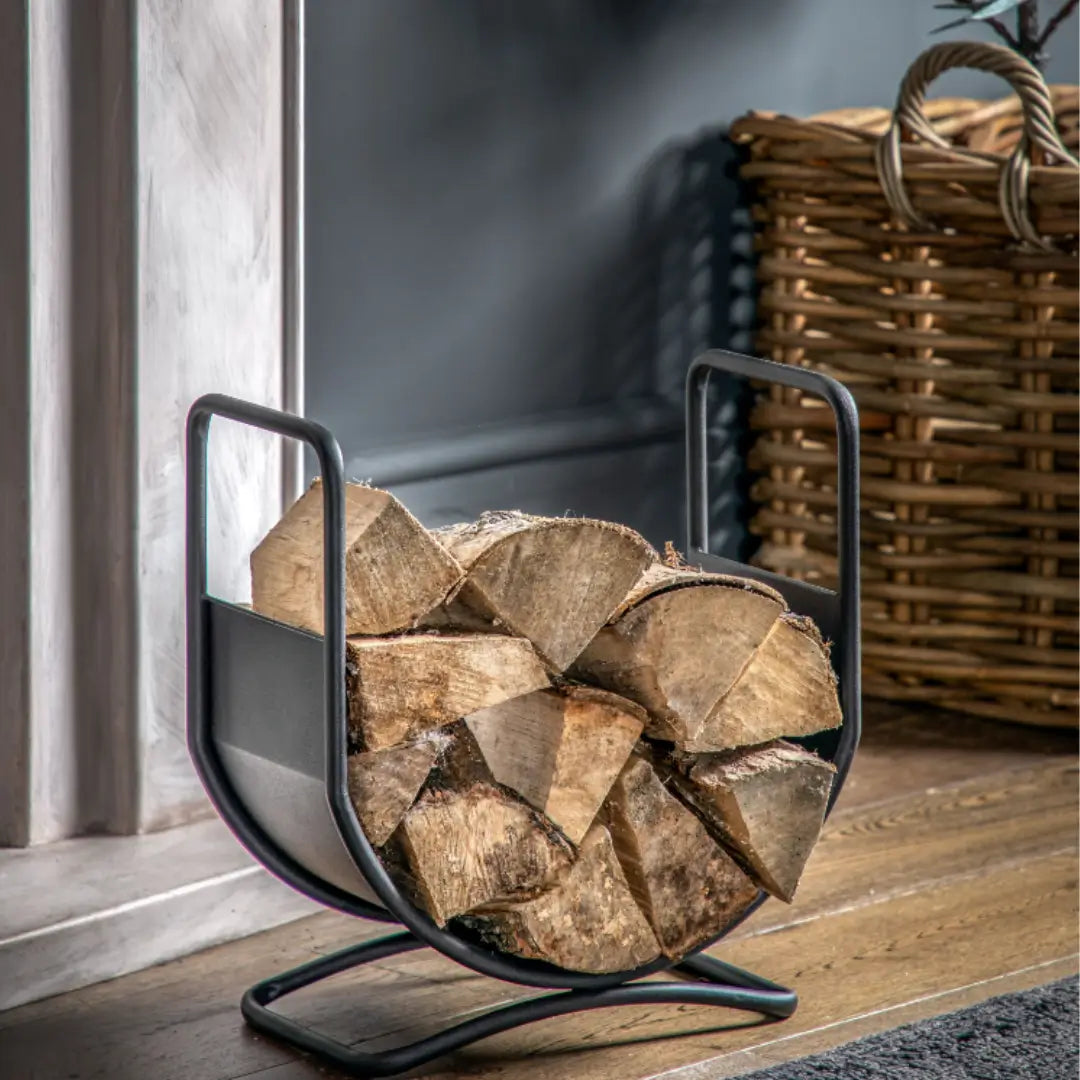 Log holder basket for fireplaces crafted from iron and finished in matte black, available to purchase from Albury House Interiors, homewares and luxury home accessories in the UK.