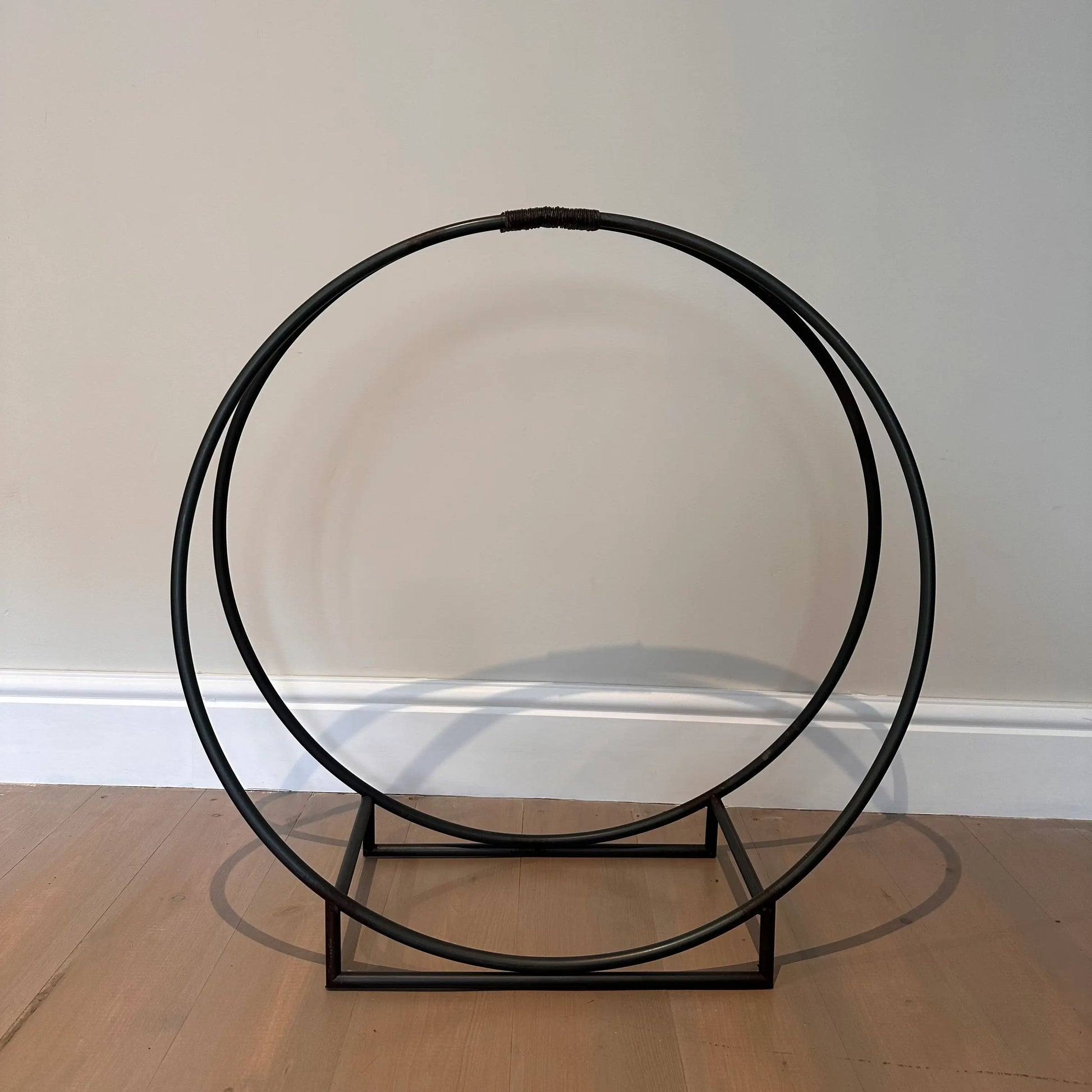 black-metal-circular-shaped-log-holder-at-albury-house-interiors