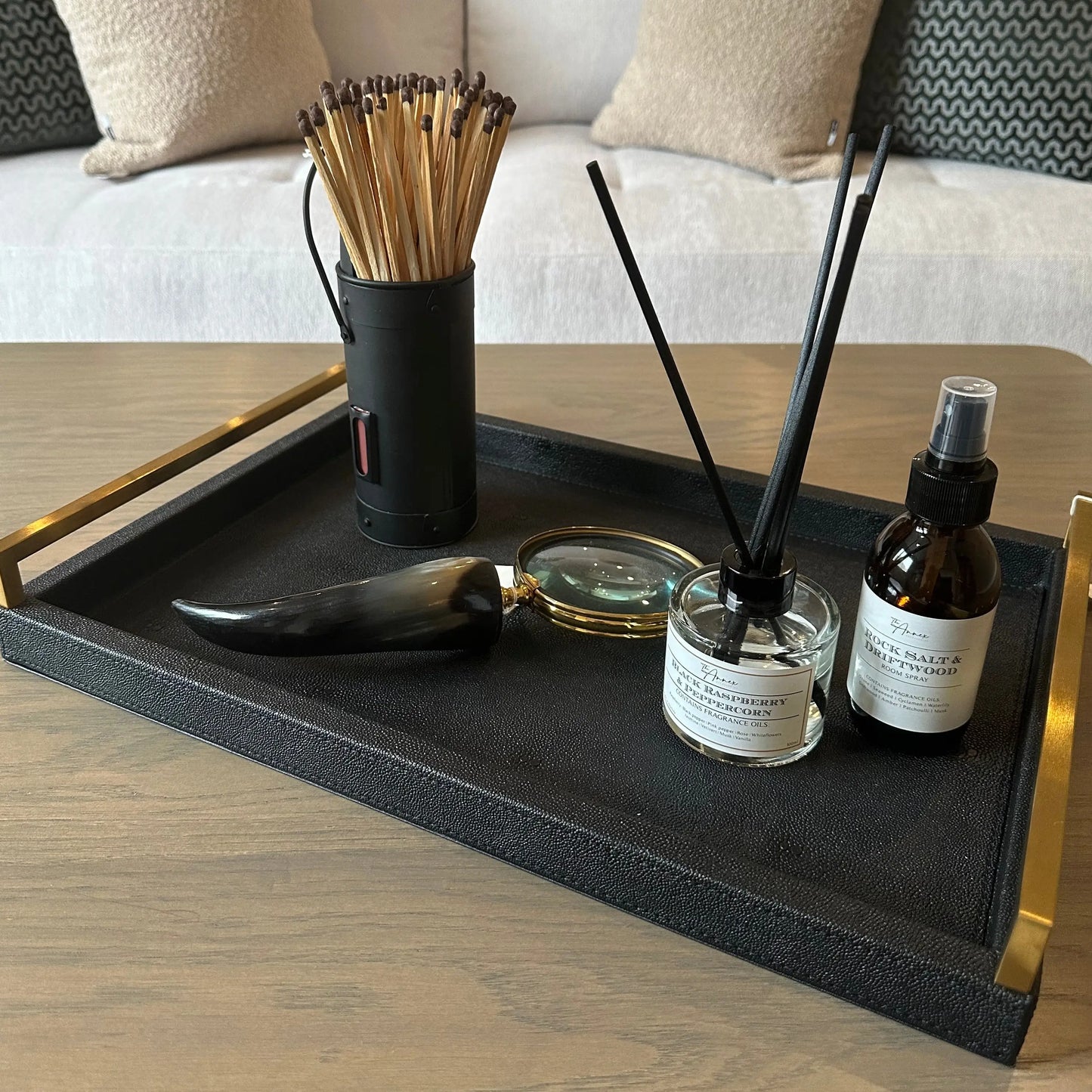 black-faux-shagreen-rectangular-tray-with-brushed-faux-gold-handles-displaying-black-accessories-at-albury-house-interiors