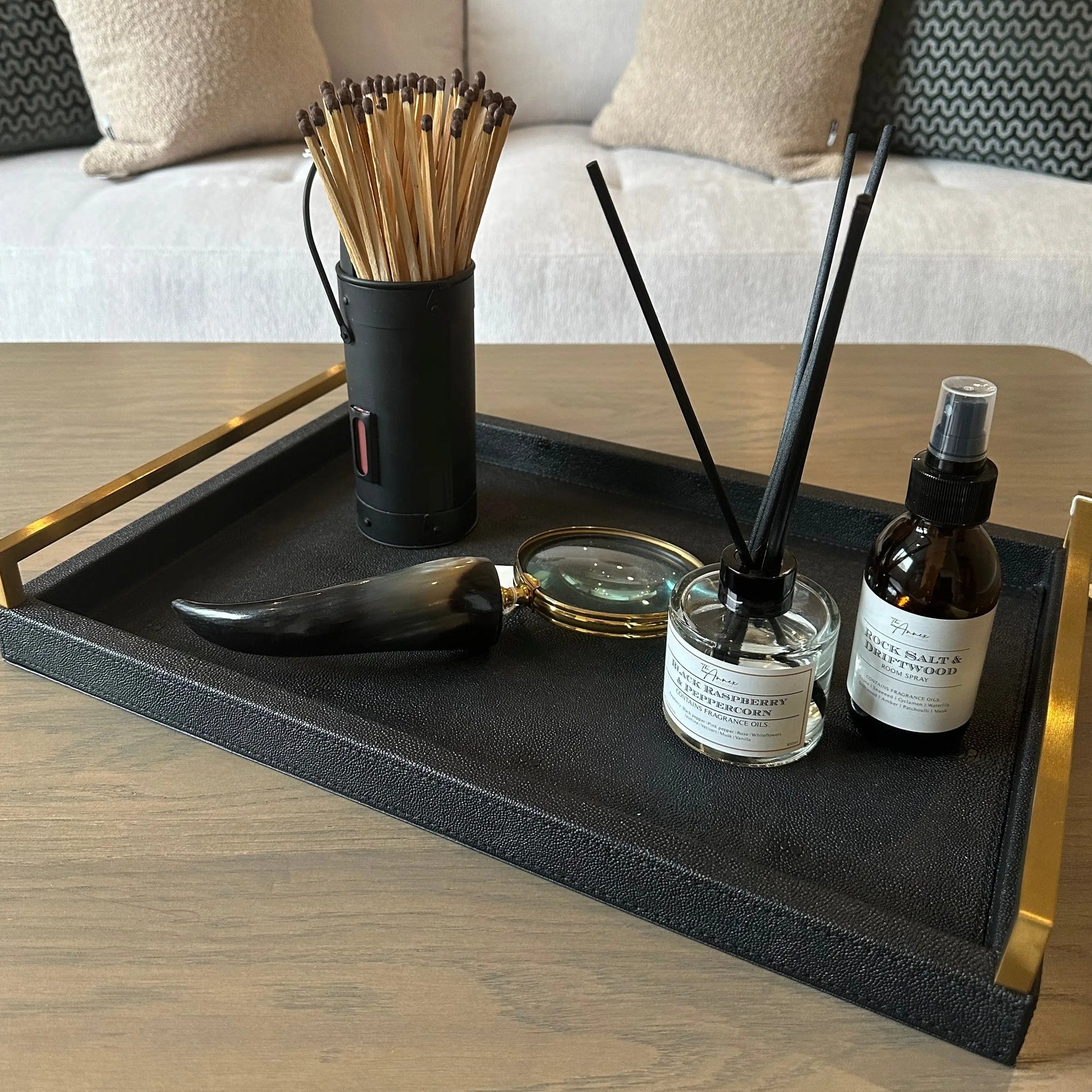 black-faux-shagreen-rectangular-tray-with-brushed-faux-gold-handles-displaying-black-accessories-at-albury-house-interiors