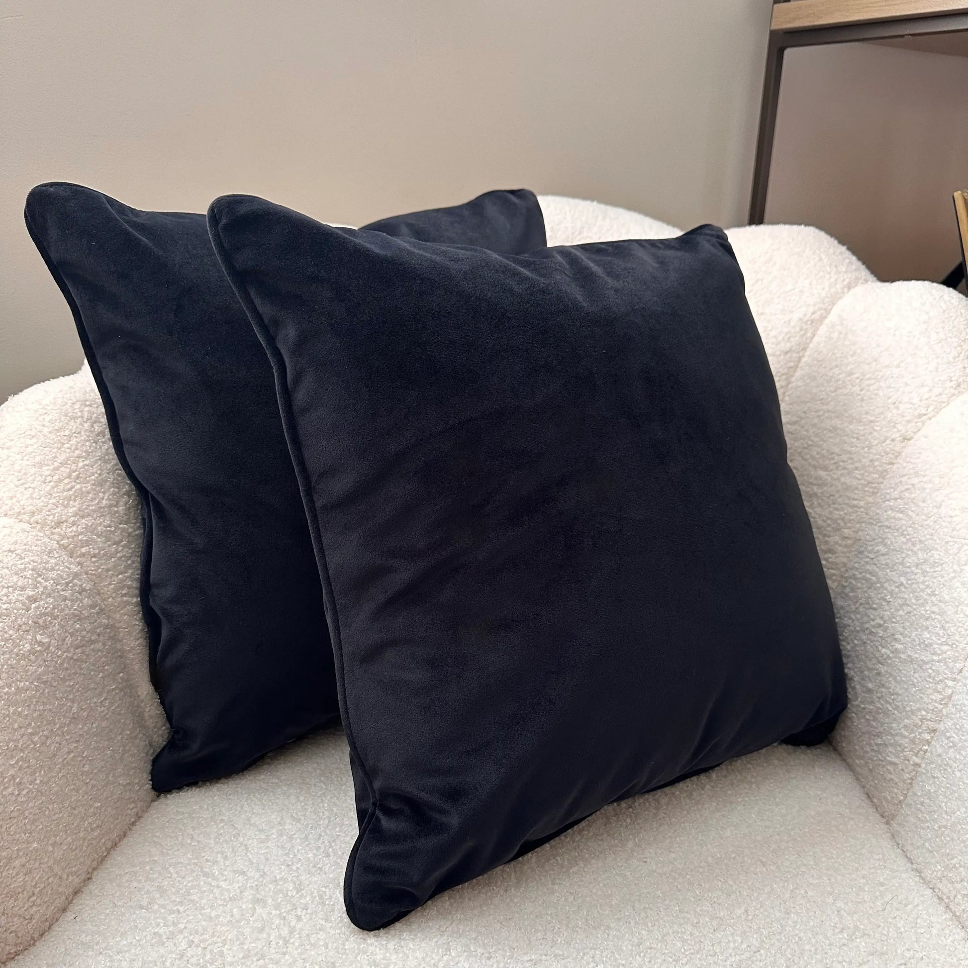 Black soft velvet square cushion with matching piped edges and feather filled insert at Albury House Interiors homewares in Essex, Hertfordshire and London
