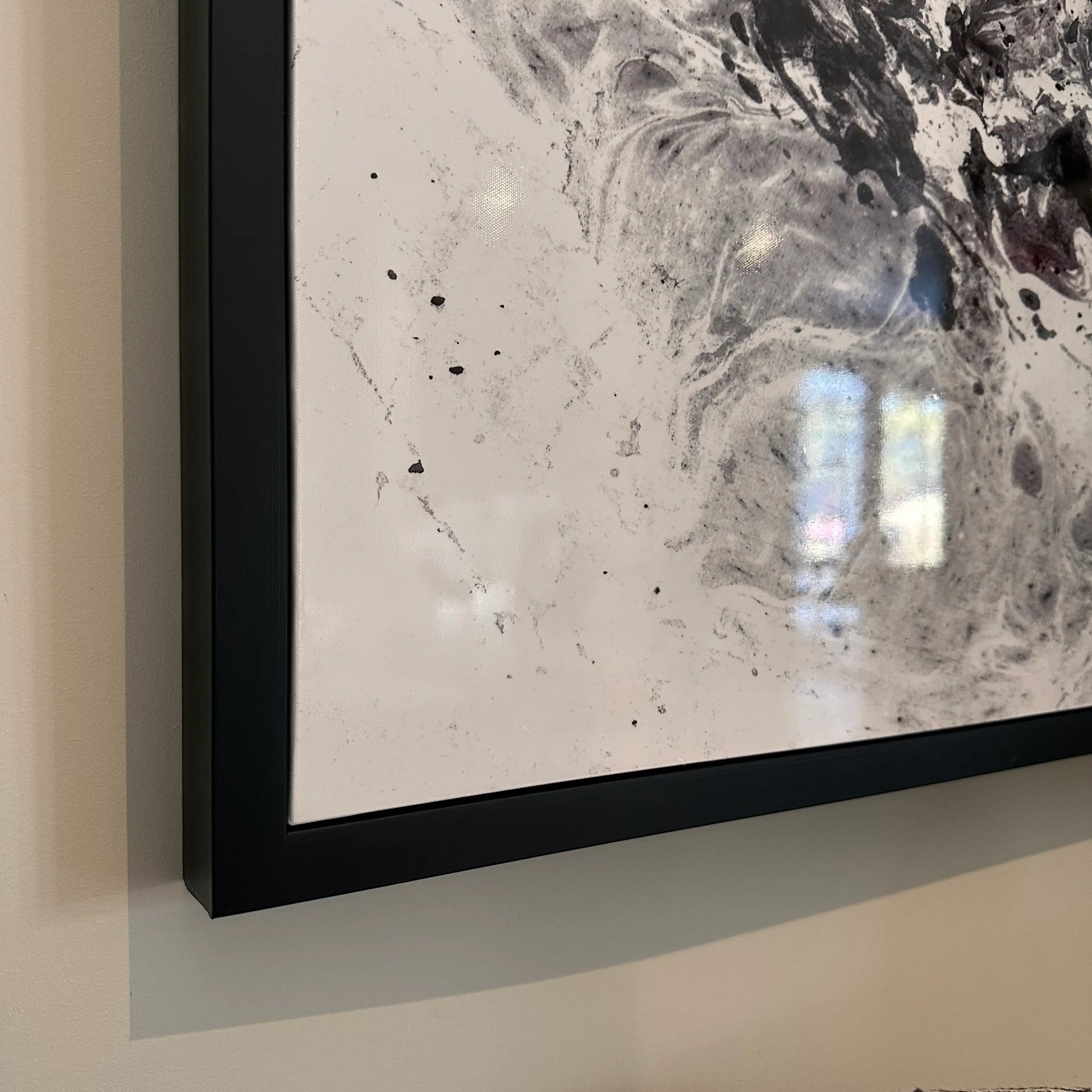 close-up-of-black-and-white-gloss-galaxy-swirls-artwork-in-black-pine-frame-at-albury-house-interiors