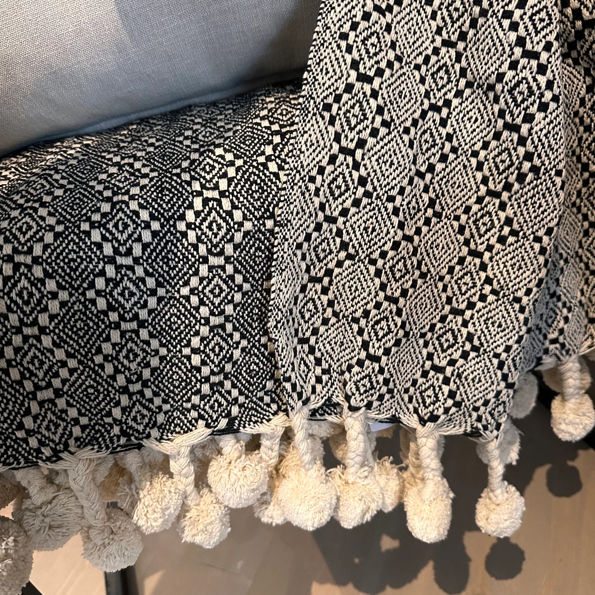 black-and-white-cotton-aztec-pattern-throw-with-pompom-edge-fringing-at-albury-house-interiors