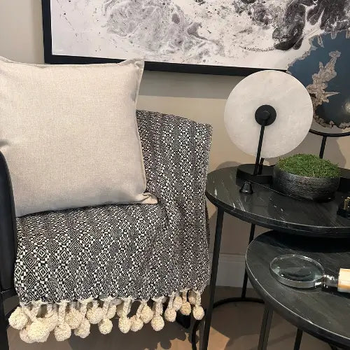 Black and white aztec patterned double sided throw, with cream pompom edges. Available to purchase from Albury House Interiors. 