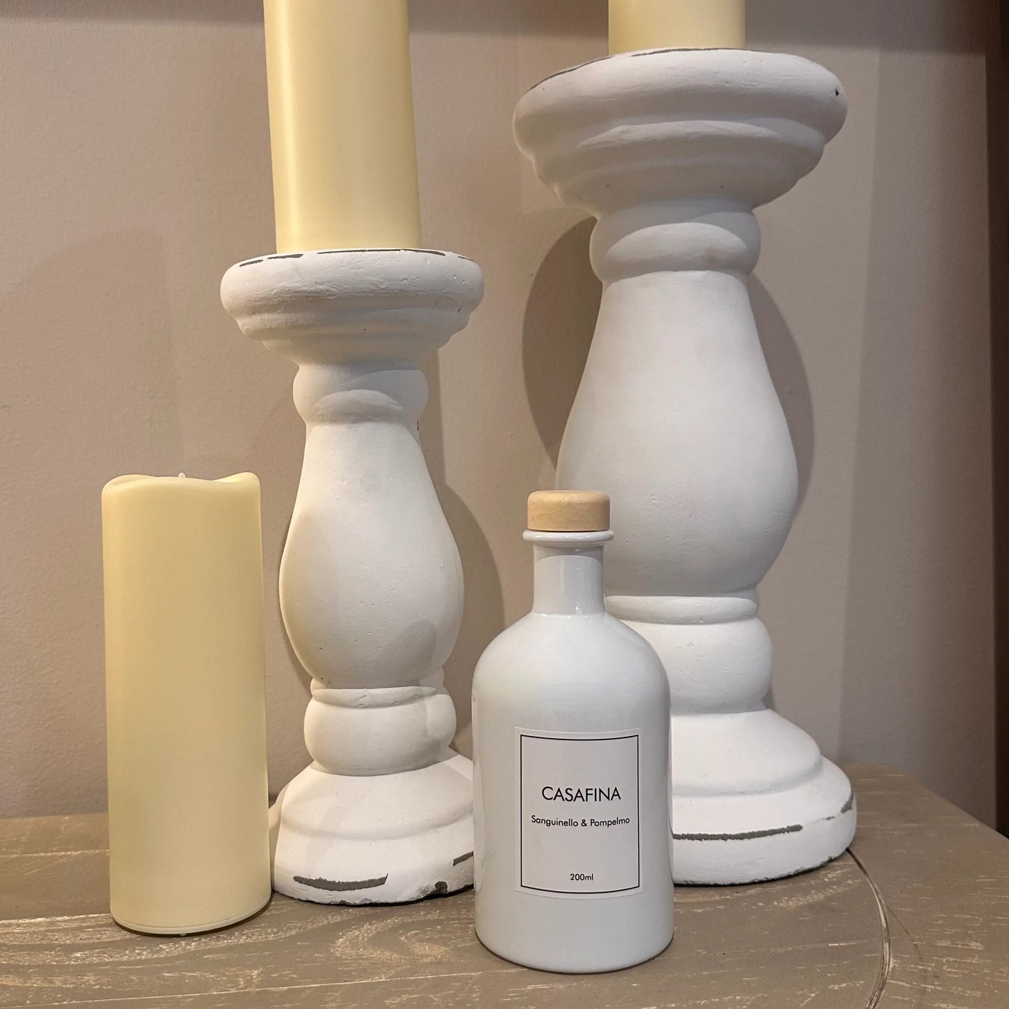 casafina-blood-orange-and-grape-reed-diffuser-home-scent-in0yellow-gift-box-with-white-large-candle-holders-and-pillar-candles-at-albury-house-interiors-homewares-shop