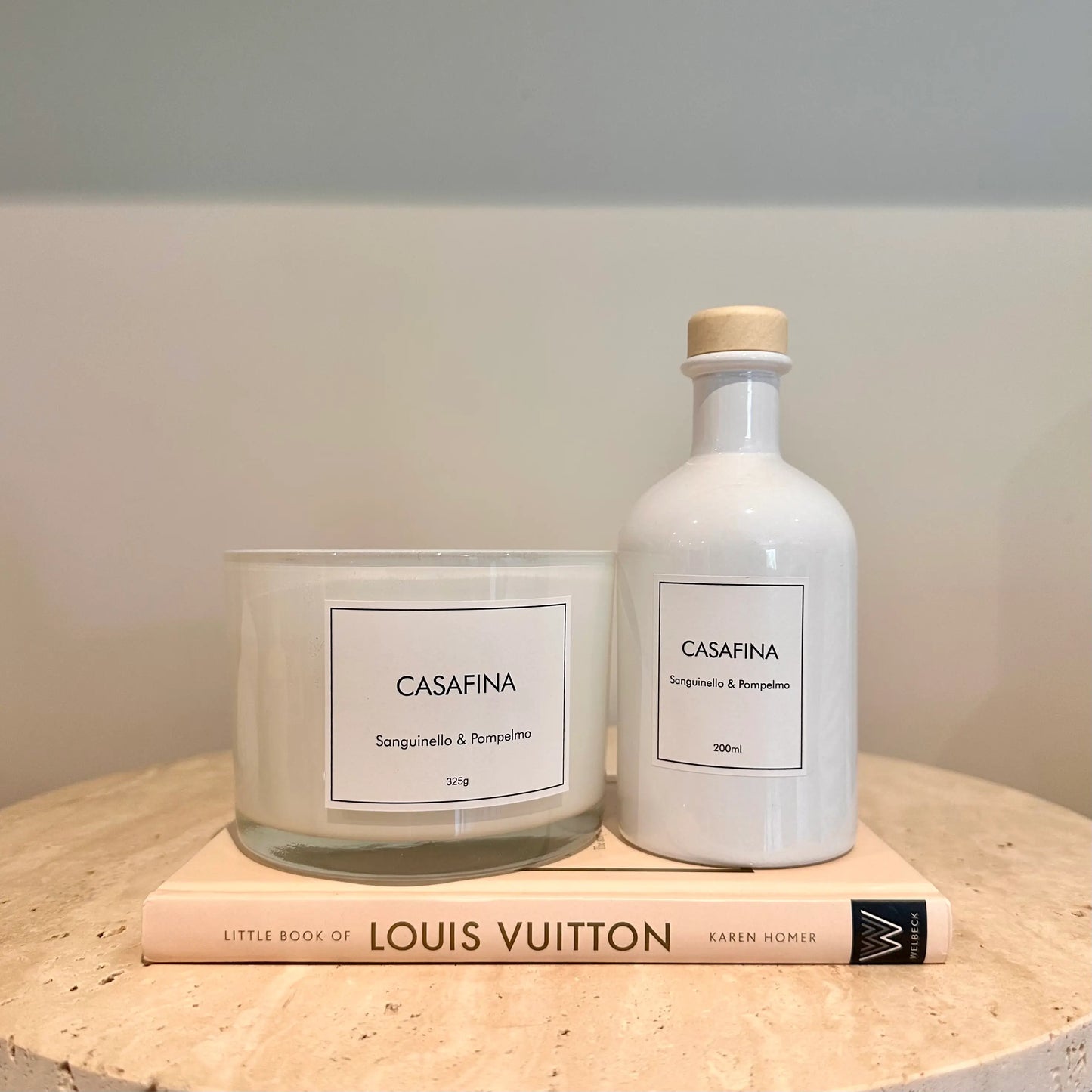 Casafina blood orange and grapefruit scented, white glass candle with three wicks, beautifully presented in a yellow gift box, available to purchase at Albury House Interiors. 
