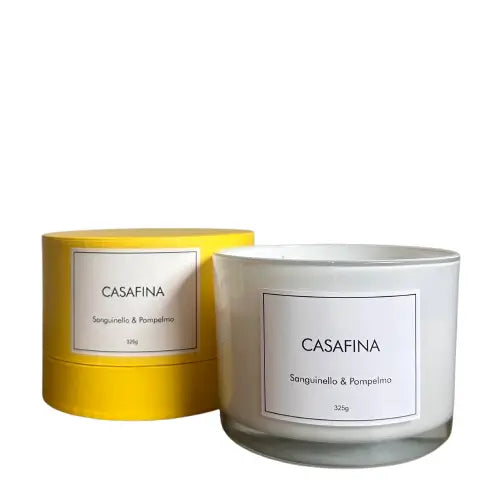Casafina blood orange and grapefruit scented, white glass candle with three wicks, beautifully presented in a yellow gift box, available to purchase at Albury House Interiors. 