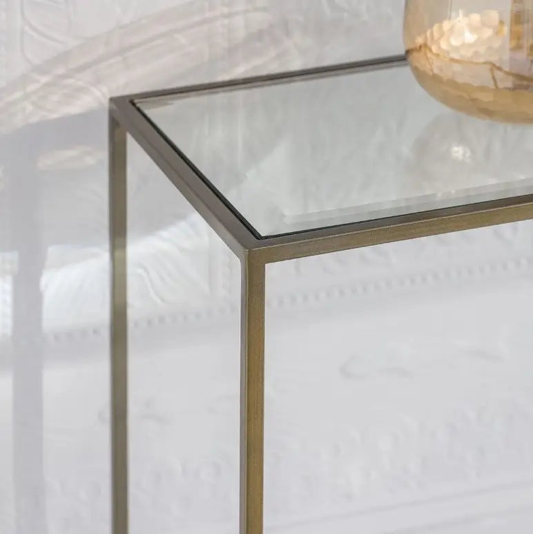 Bronze finished metal slim console table with glass top, perfect for living rooms, dining rooms and hallways. Available at Albury House Interiors. 