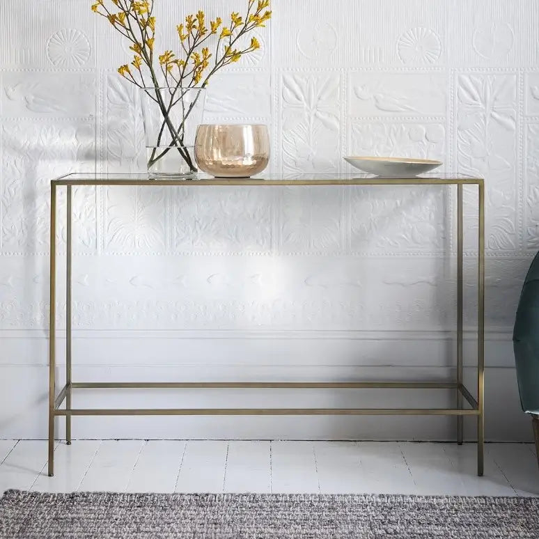 Bronze finished metal slim console table with glass top, perfect for living rooms, dining rooms and hallways. Available at Albury House Interiors. 