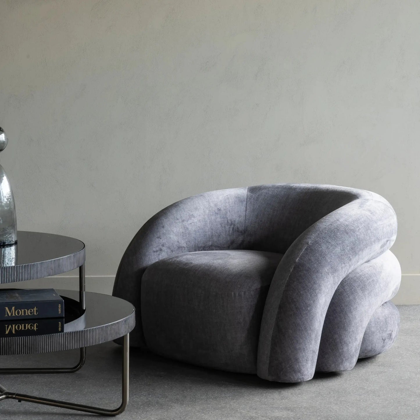 Bruges oversized curved bubble armchair, upholstered in grey velvet. Available to purchase from Albury House Interiors in both grey and ivory.