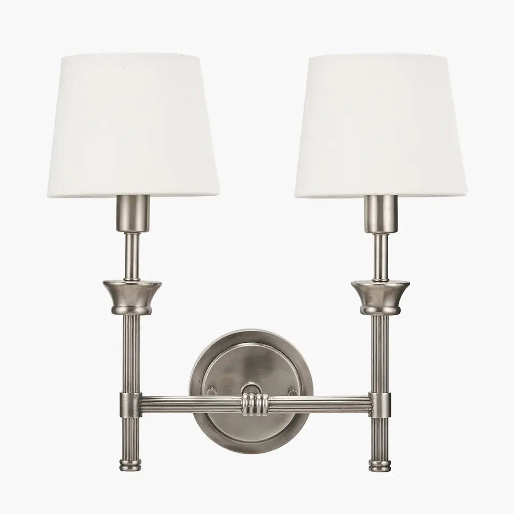brushed-silver-cast-brass-double-wall-light-with-white-cottom-shades-in-living-room-with-soft-ighting-at-albury-house-interiors