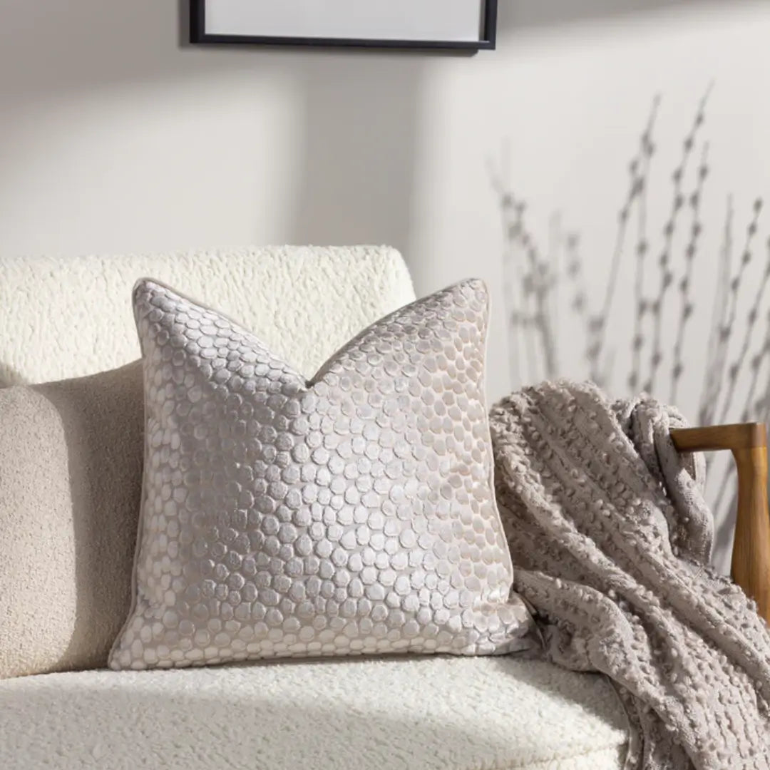 Ivory velvet square cushion with bubble textured pattern on the front and plain velvet on the reverse. Complete with matching ivory piped edges and feather filled insert. Available to purchase at Albury House Interior, home decor in the UK. 
