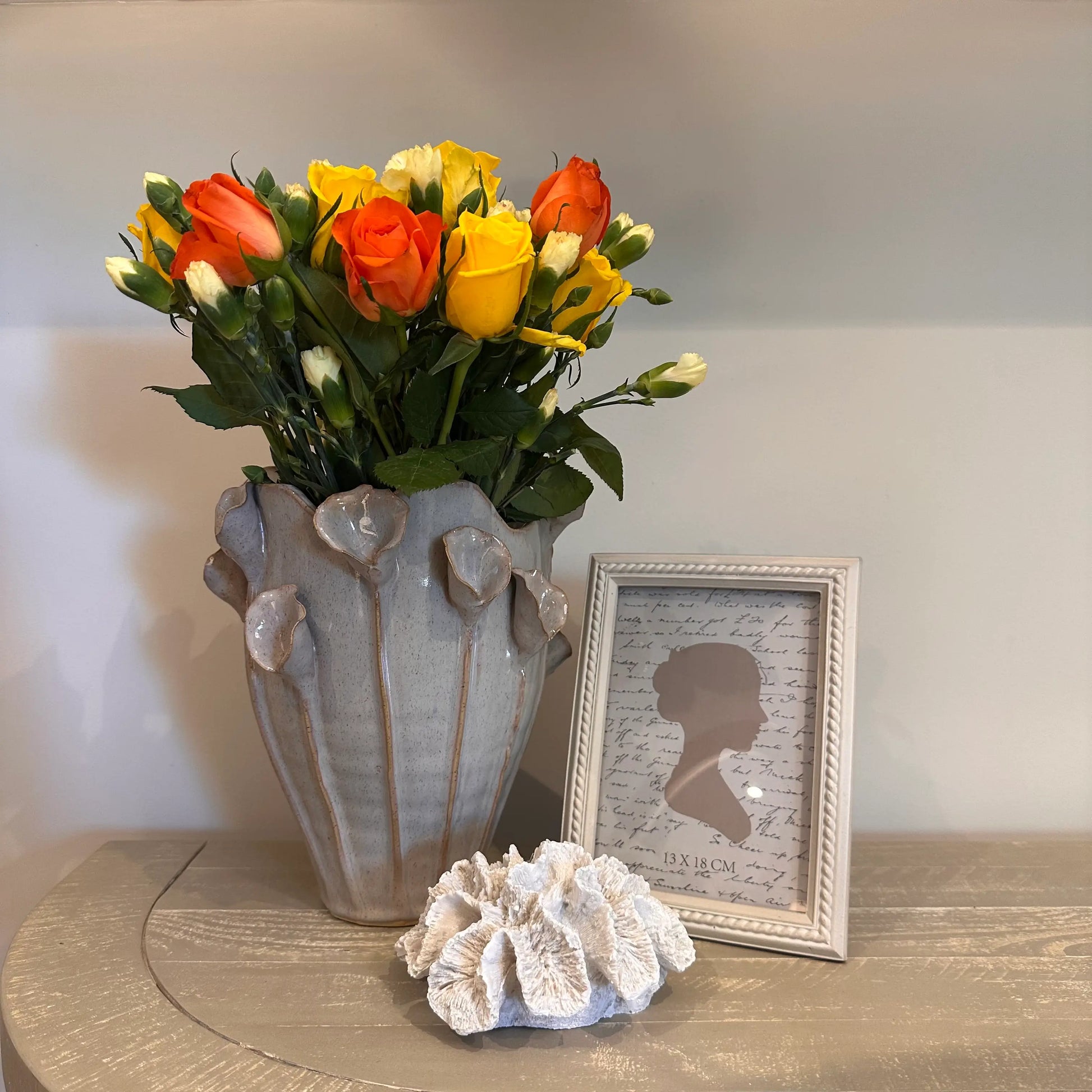 ceramic-lilac-calla-lily-vase-with-beaded-neutral-coloured-photoframe-and-faux-white-coral-at-albury-house-interiors-essex