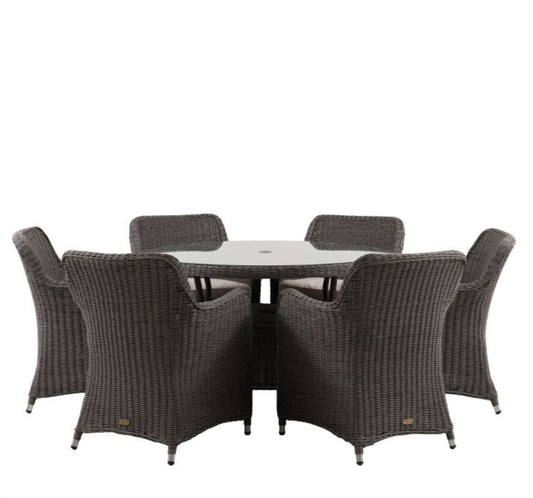 A 7-piece outdoor dining set featuring a round glass-top table and six grey woven wicker armchairs, shown against a plain white background. Available at Albury House Interiors.
