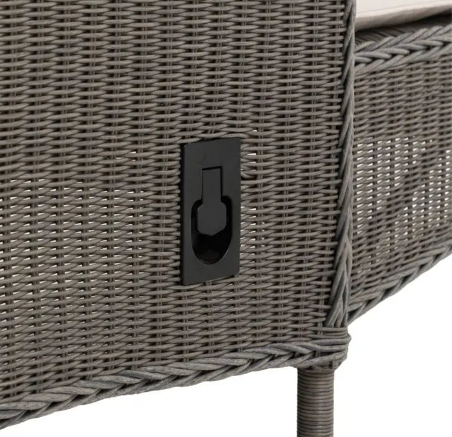 An outdoor reclining wicker Lounger with a tall backrest, featuring light beige cushions on the seat and back, set against a plain white background.