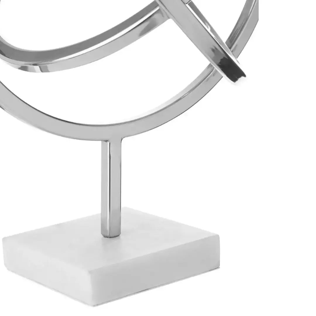 chrome-siver-spiral-round-sculpture-on-marble-base-at-albury-house-interiors